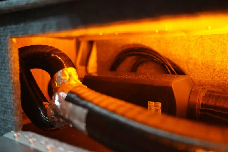 Compact eberspächer heater installed in an interior compartment.