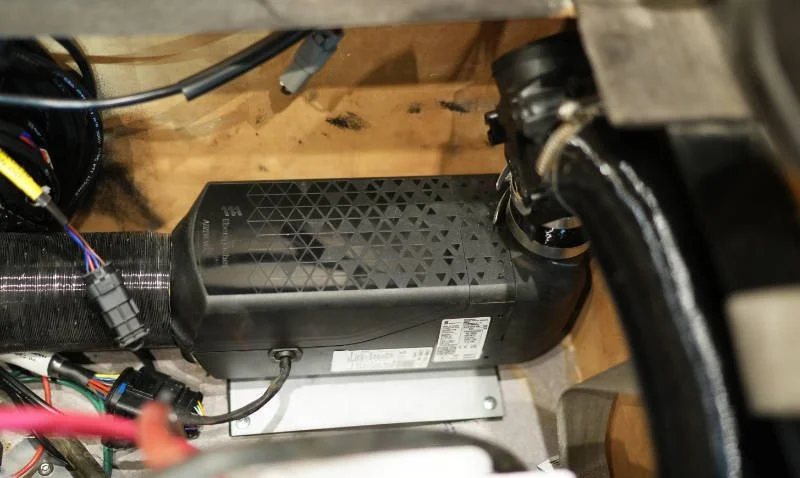 An Eberspächer compact heater installed inside a van with ducting connected.