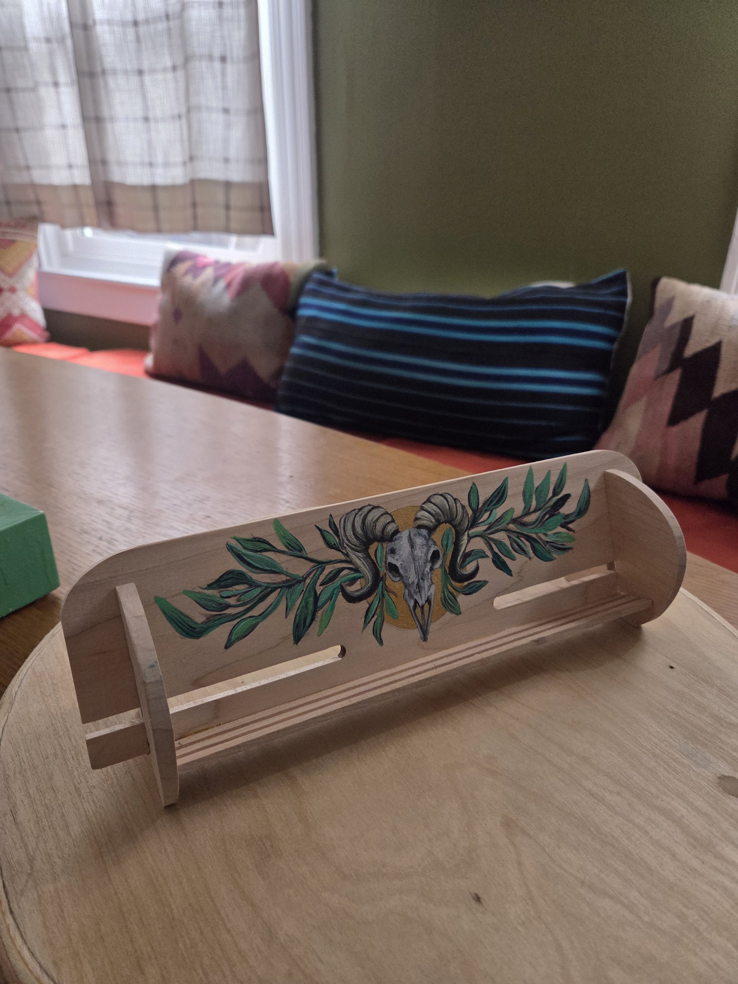 Tarot card holder with hand painted ram skull and plants.
