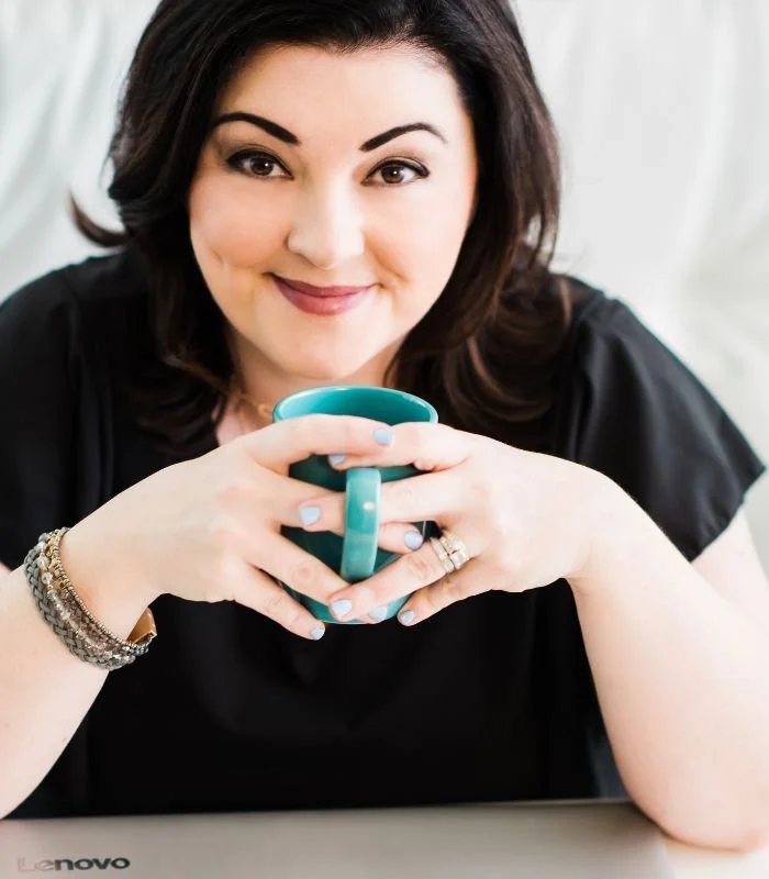 Jennifer Calero owner of Small Talk with her laptop and coffee