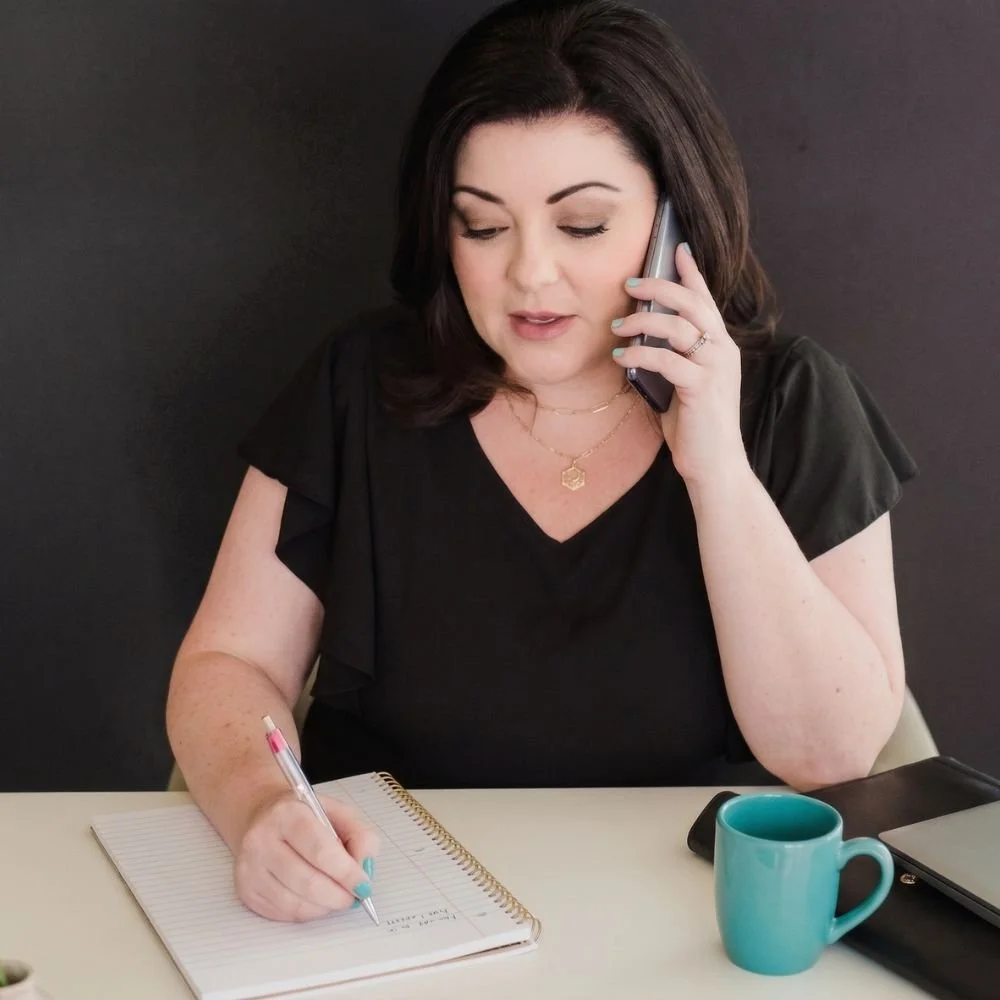 Jennifer Calero taking notes while doing a consultation with a potential client
