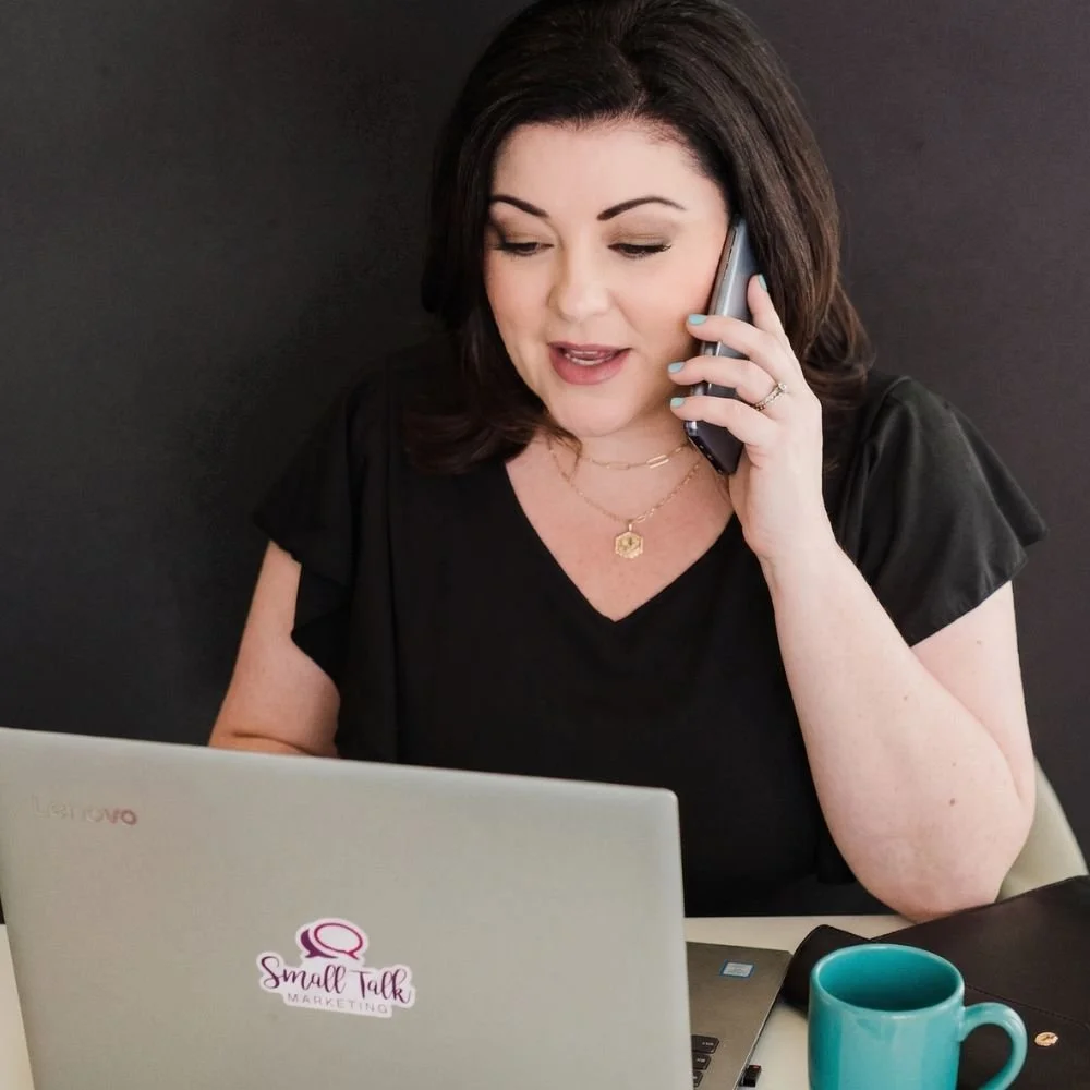 Jennifer Calero talks on a cell phone during a consultation with a client