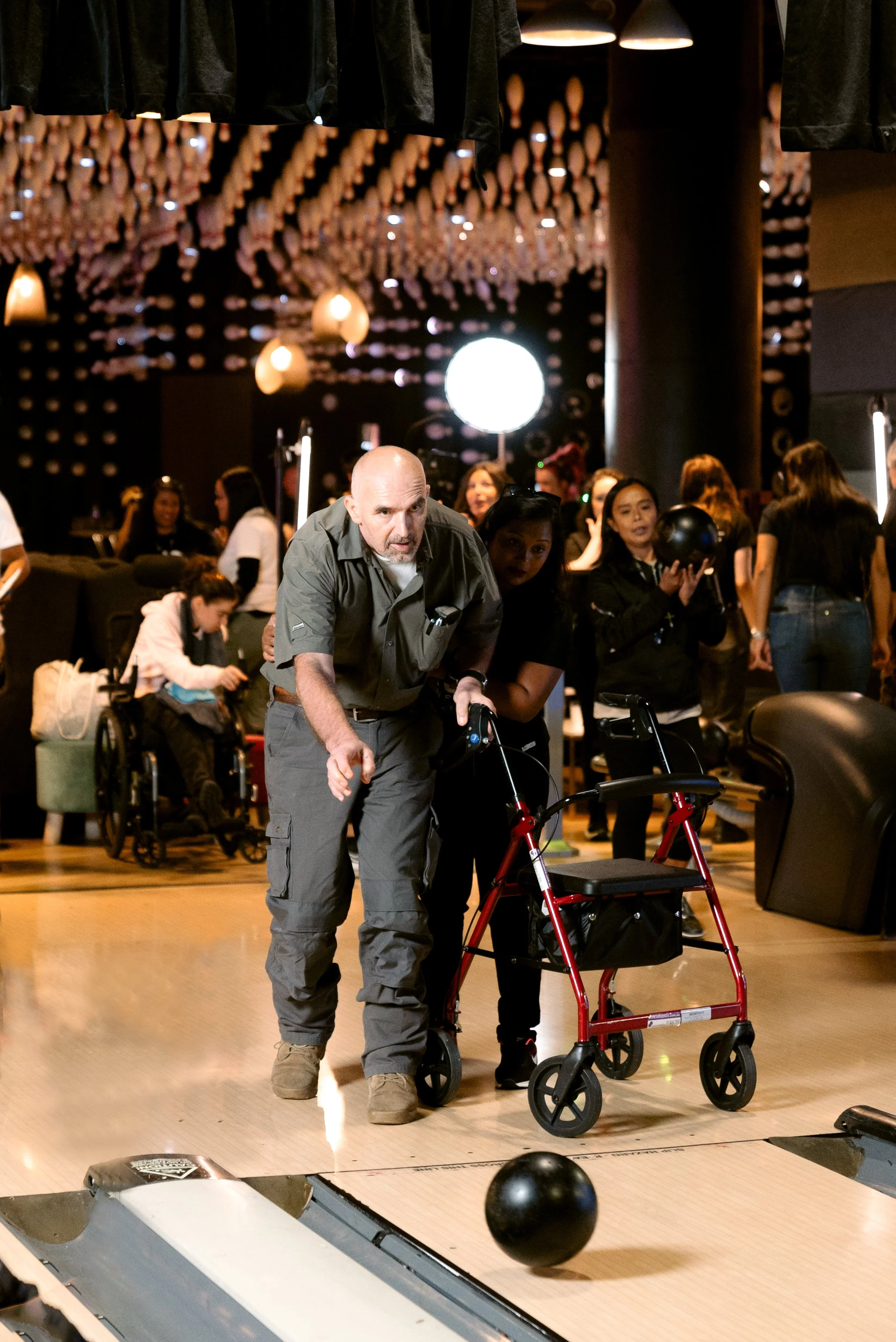Participant enjoying a game of bowling while a More Than Support Disability Support Worker provides personalised support to encourage independence and community participation.