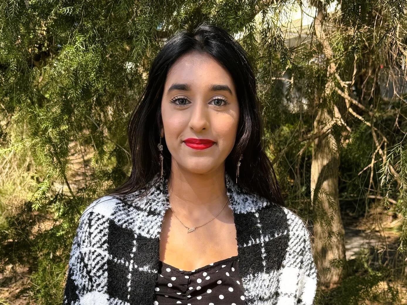 Alesha Kumar standing in front of a tree in Bella Vista