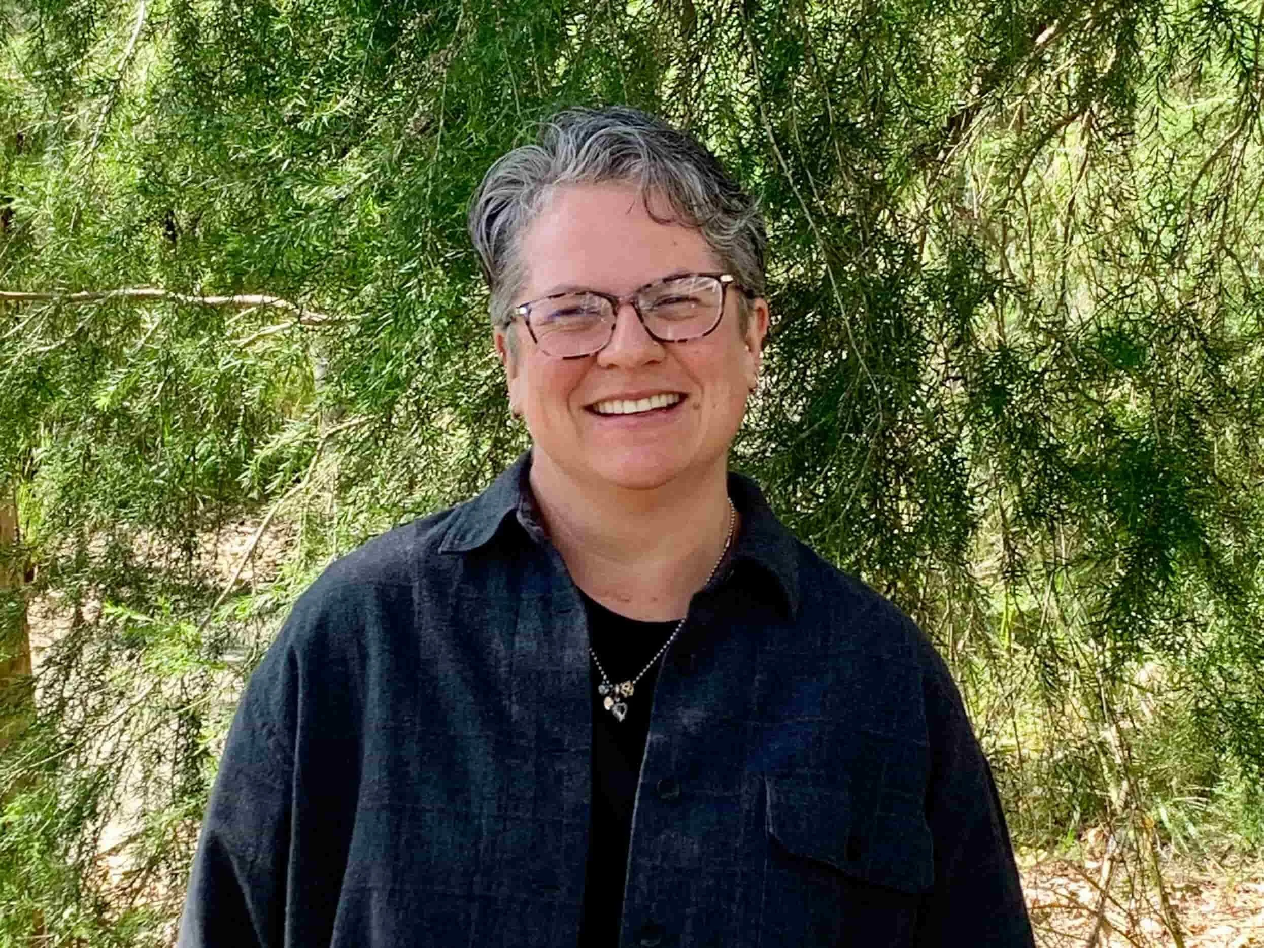 Nicki Kemp standing in front of a tree