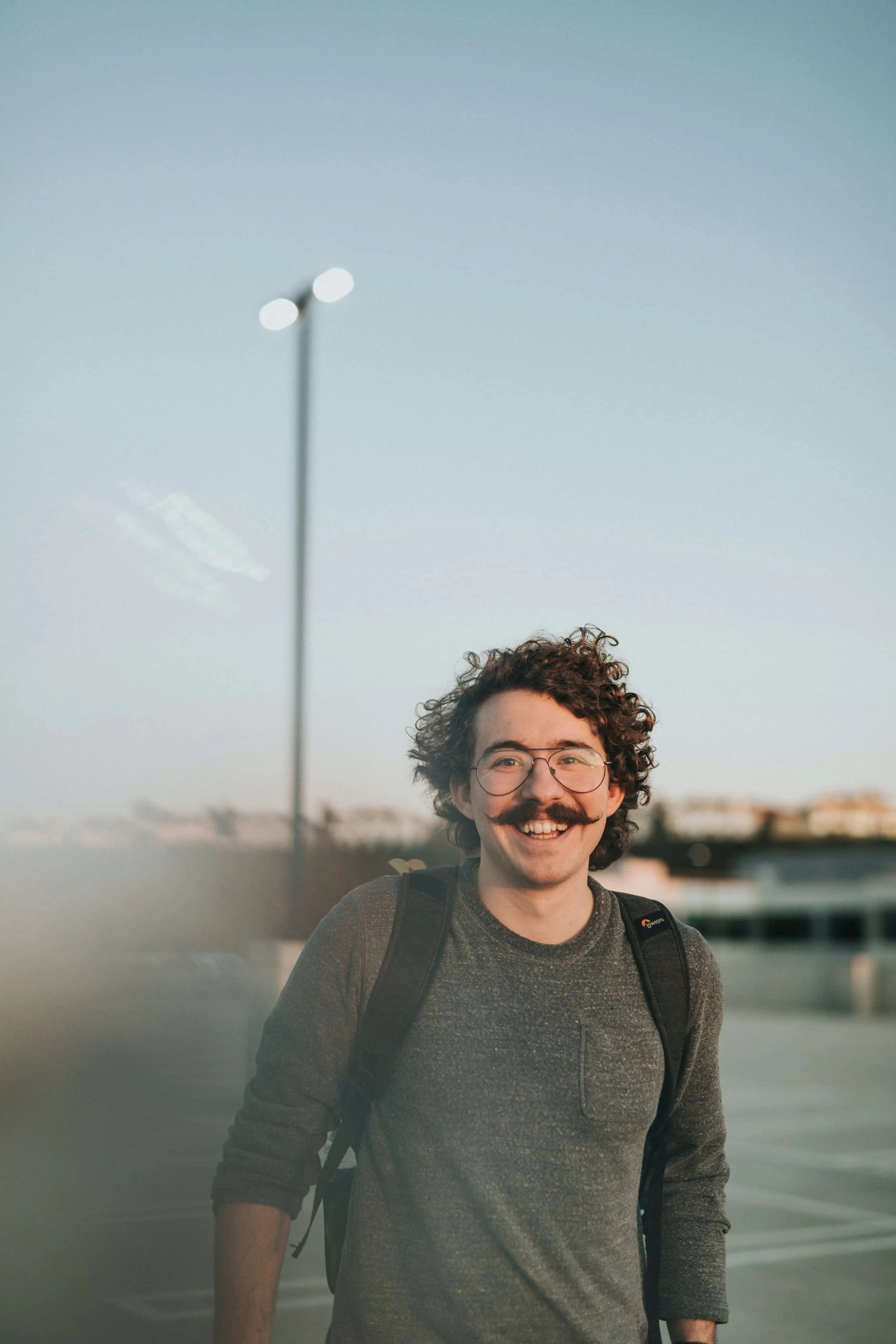 Smiling young man with a moustache at the seaside