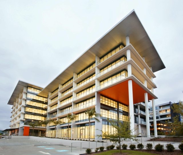 Exterior picture of the Alpha building, a modern multi-story building with large windows in Bella Vista, home to the Northwest Psychology Practice