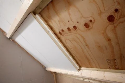 Dakraam en isolatiematerialen in een zolder tijdens renovatie.