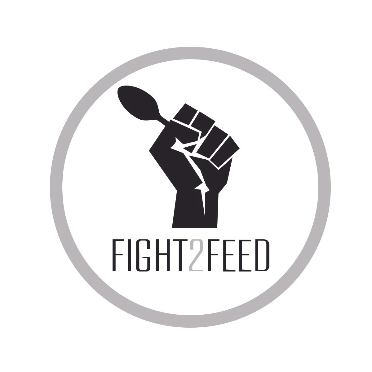 A black silhouette of a raised fist holding a spoon with the words "FIGHT 2 FEED" underneath, surrounded by a grey circular border.