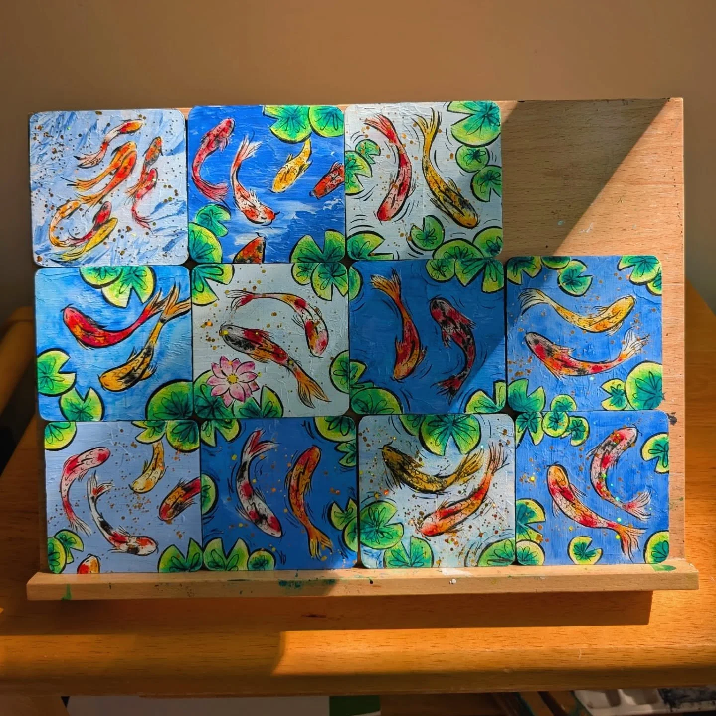 I've been painting a ton of birds on wood tiles, but I was also having so much fun playing with watercolor crayons that I was itching to find ways to use them. Thus began the koi series 🤣 - mostly just for fun and to relieve stress. 

I made these a