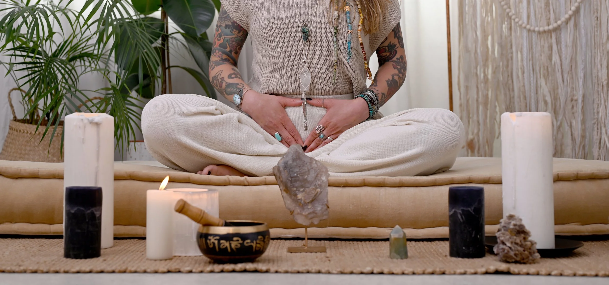 Website banner image of a yoga practitioner in a meditative pose, representing calm, intention, and spiritual branding.