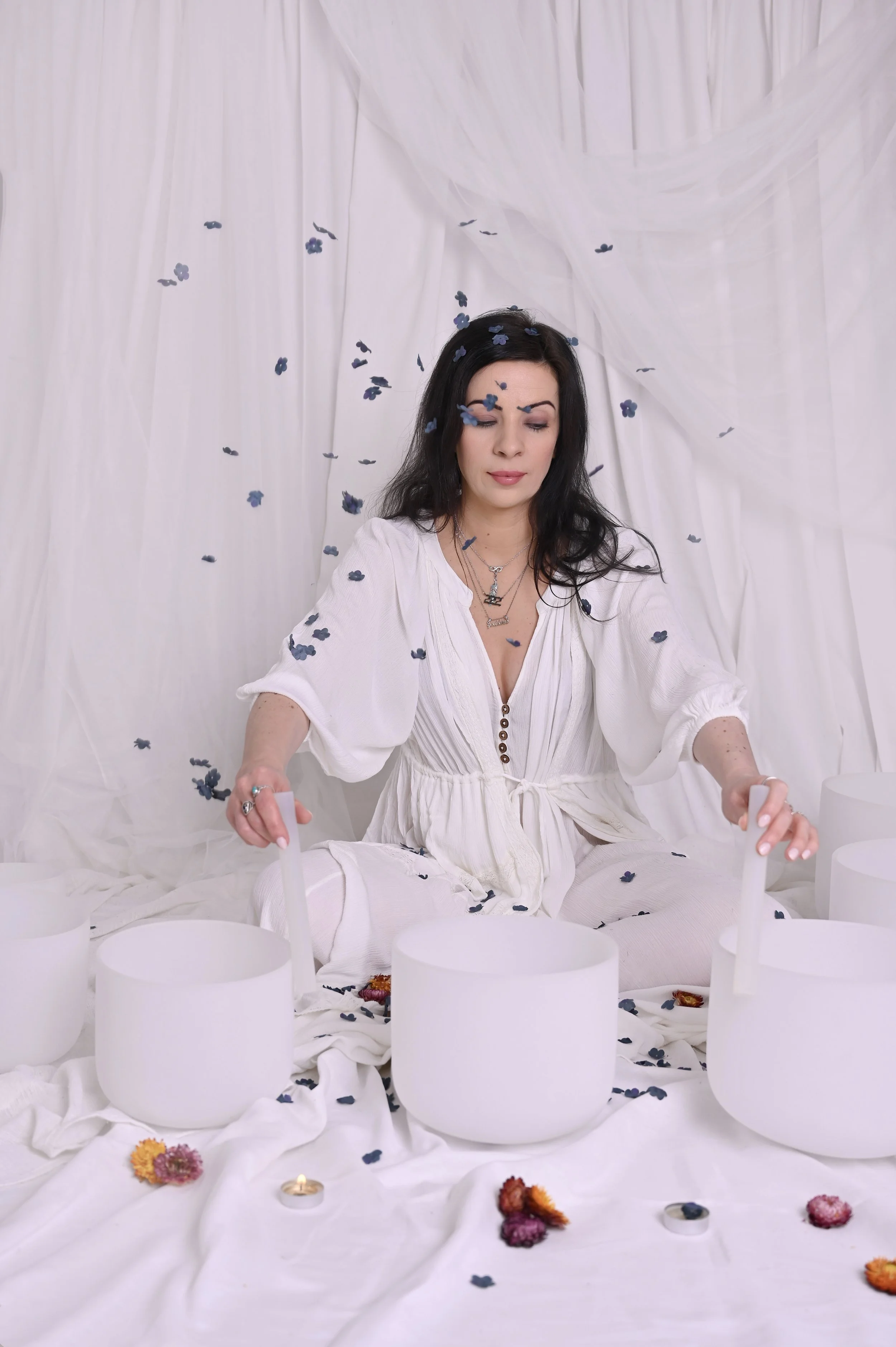 Therapy coach leading a soundbath during a personal branding shoot, captured in a studio setting for her wellness business.