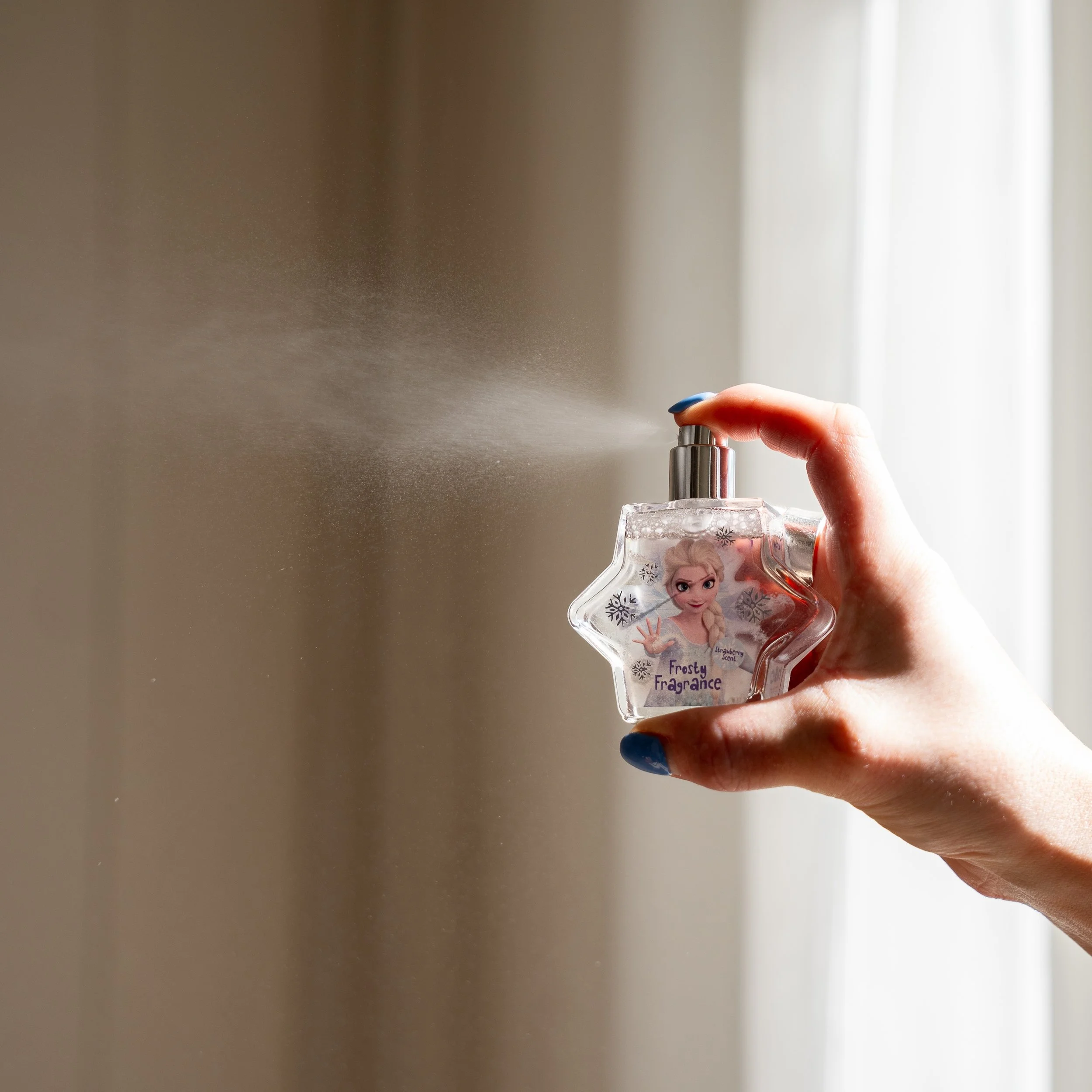Product photography of Disney Frozen Beauty perfume for Boots, capturing fragrance spray for ecommerce and retail marketing.