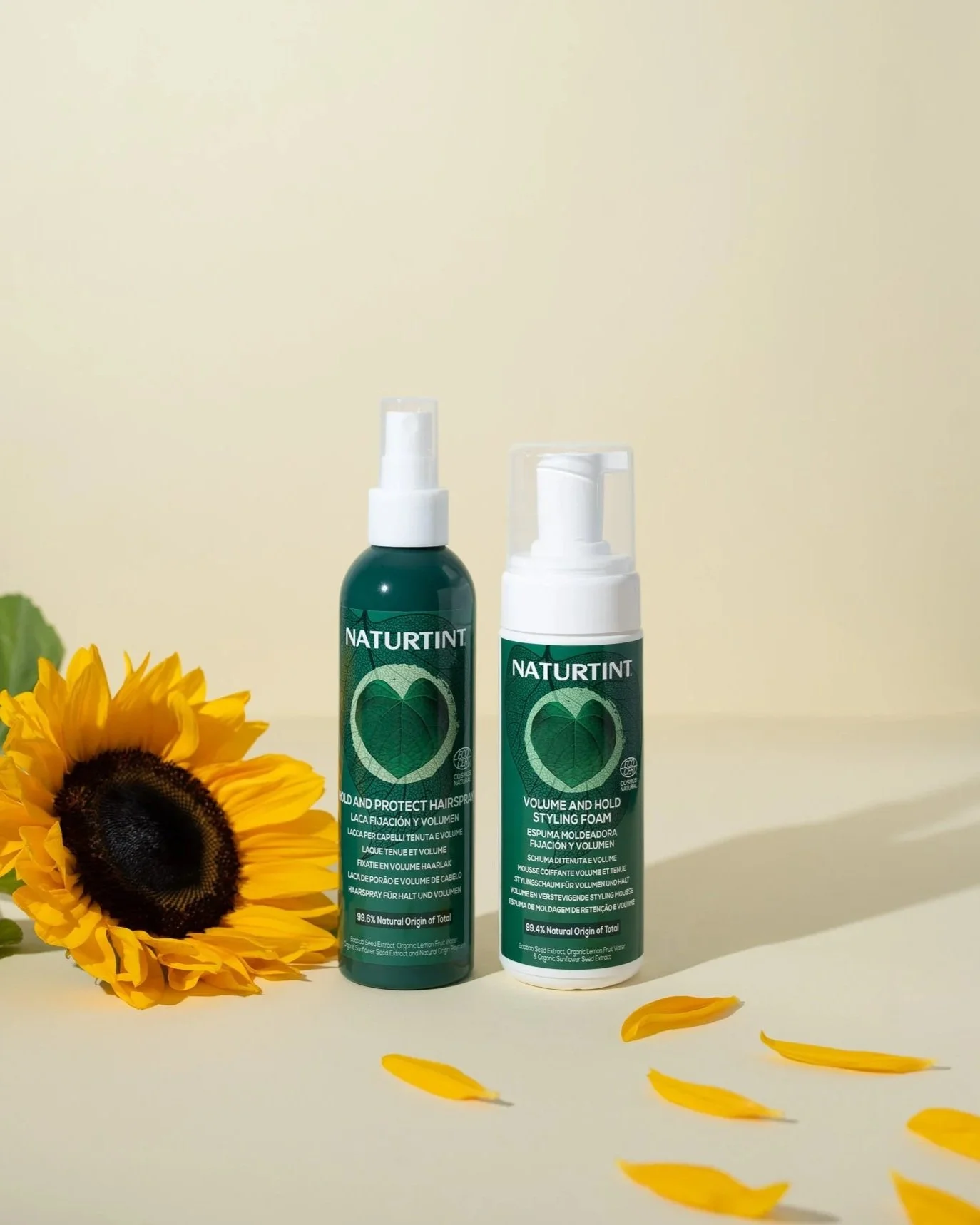 Naturtint hair styling products photographed with a sunflower and petals in a styled studio set