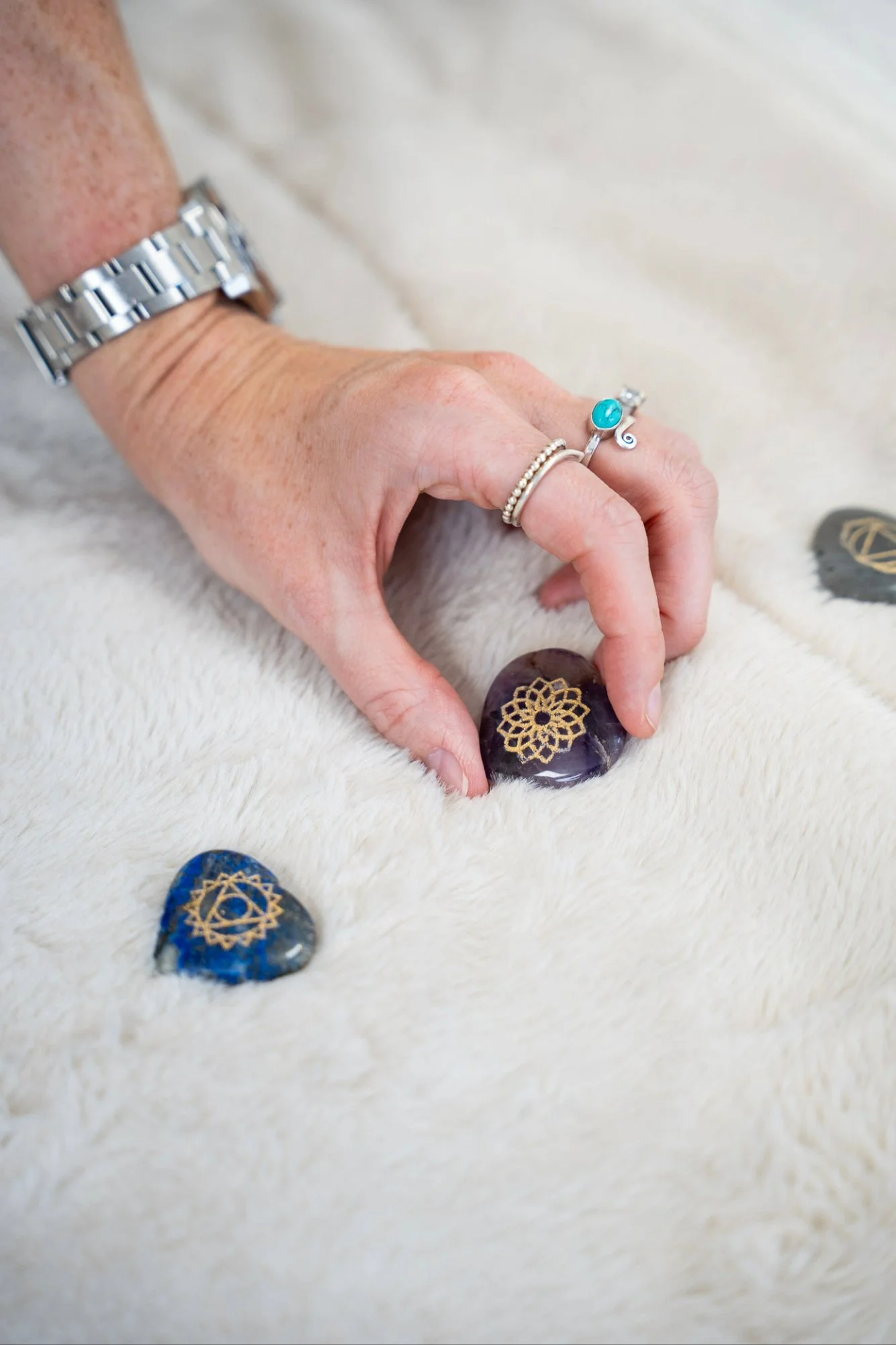 Katie from Kokoro Wellness arranging crystals as part of a Reiki session.