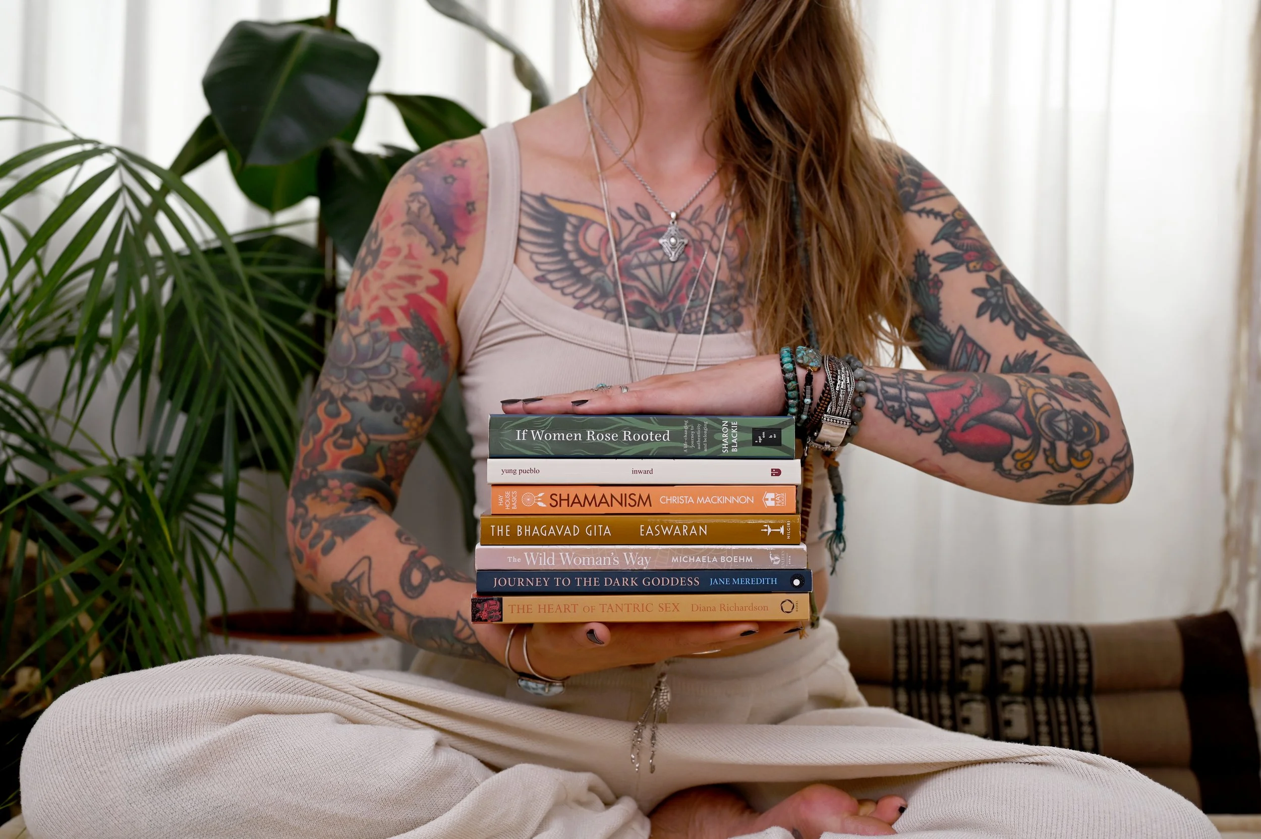 Founder brand photography of Mo holding books to reflect her coaching style and personality.
