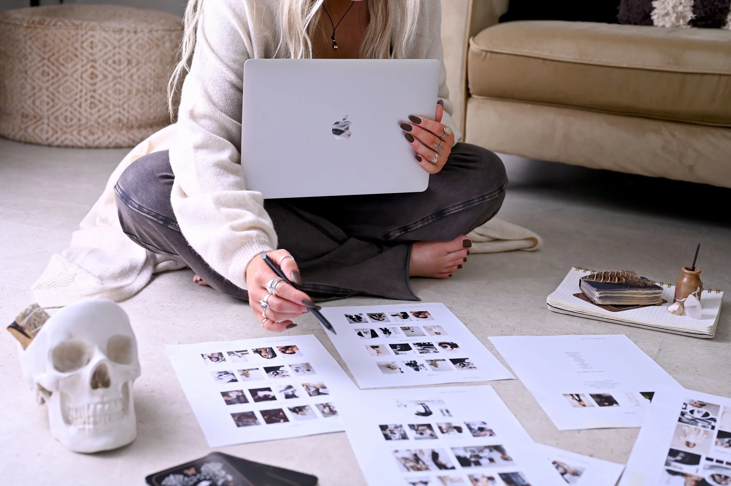 Brand photographer planning a shoot with laptop, moodboards and styling elements for a brand photography project.