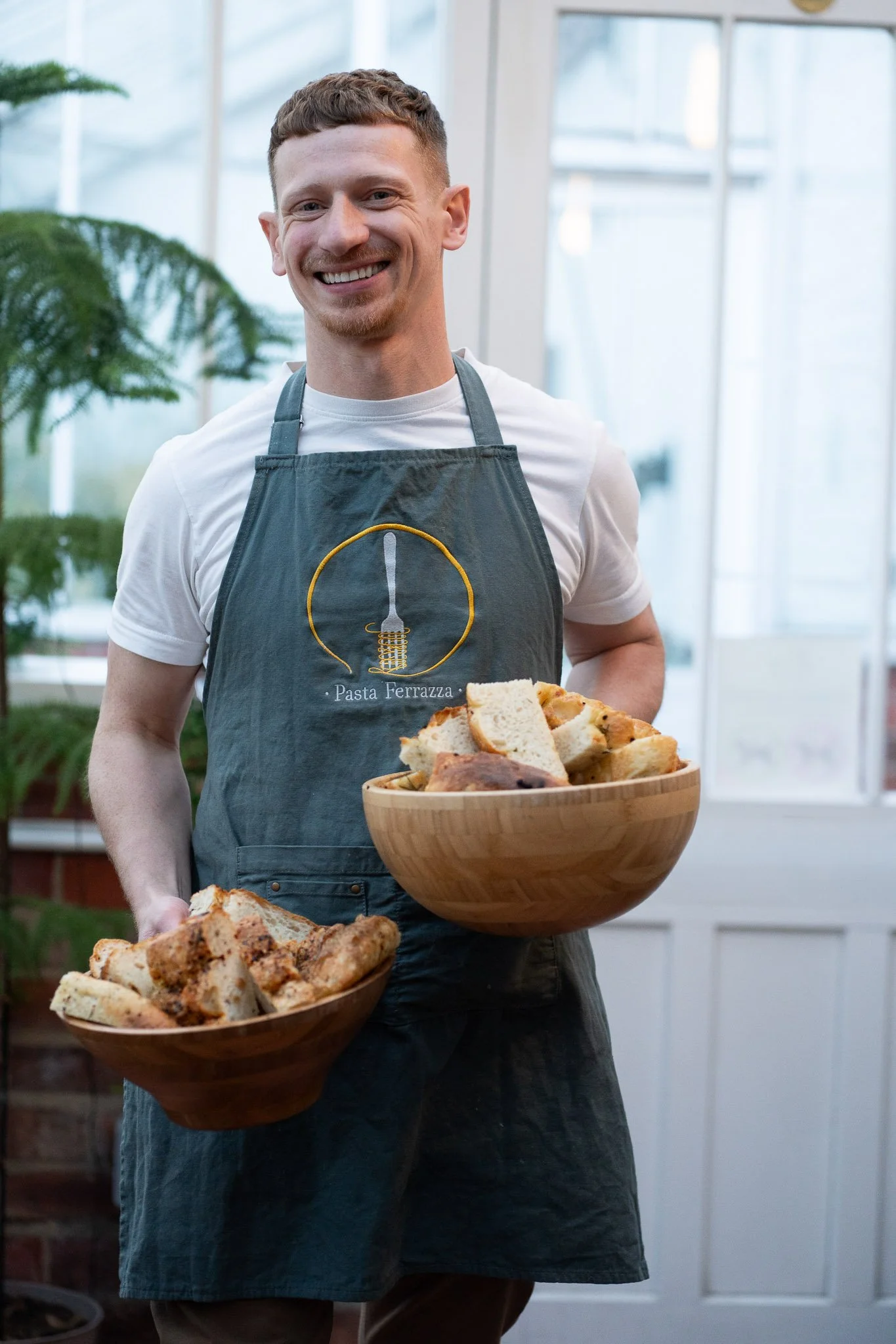 Stev from Pasta Ferrazza serving guests during a pasta making class at Grappenhall Walled Garden in Warrington.