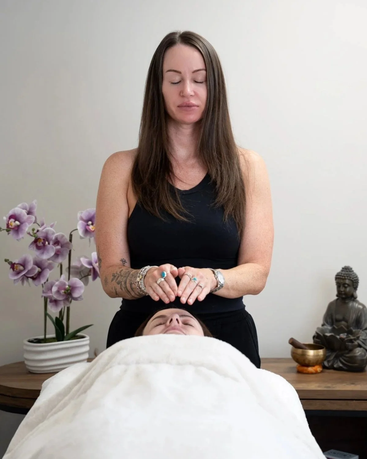 Katie from Kokoro Wellness delivering a Reiki treatment during a content creation shoot.