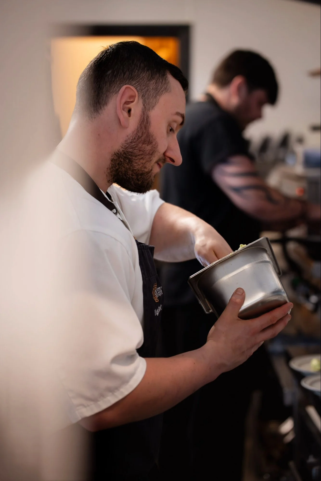 Nigel from Enigma Dining serving food during a hosted dining event.