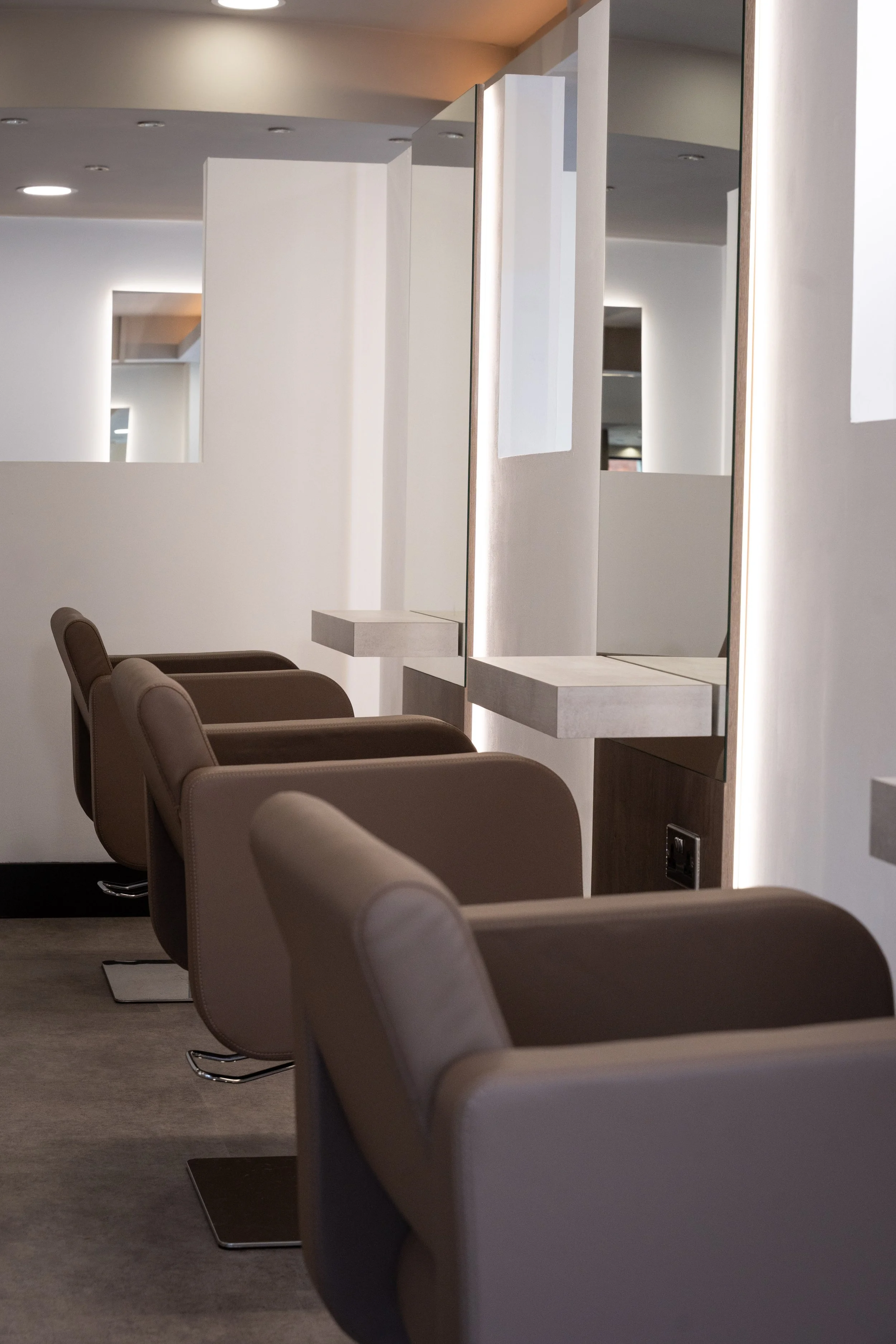 Interior photography of the styling chairs and mirrors inside Sloane The Salon in Warrington, Cheshire.
