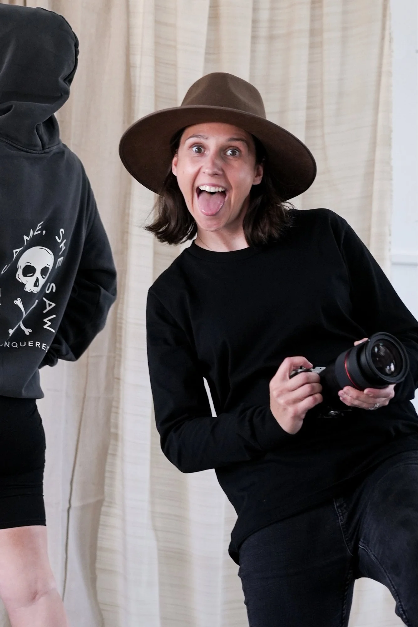 Shell smiling while holding her camera during a content creation shoot.