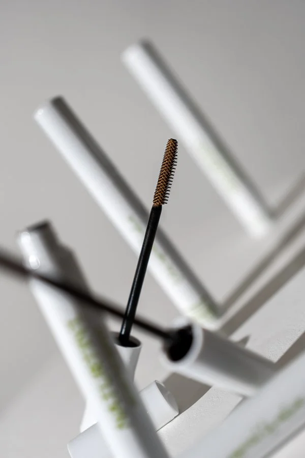 Naturtint hair mascara photographed in a styled studio setting for product imagery.