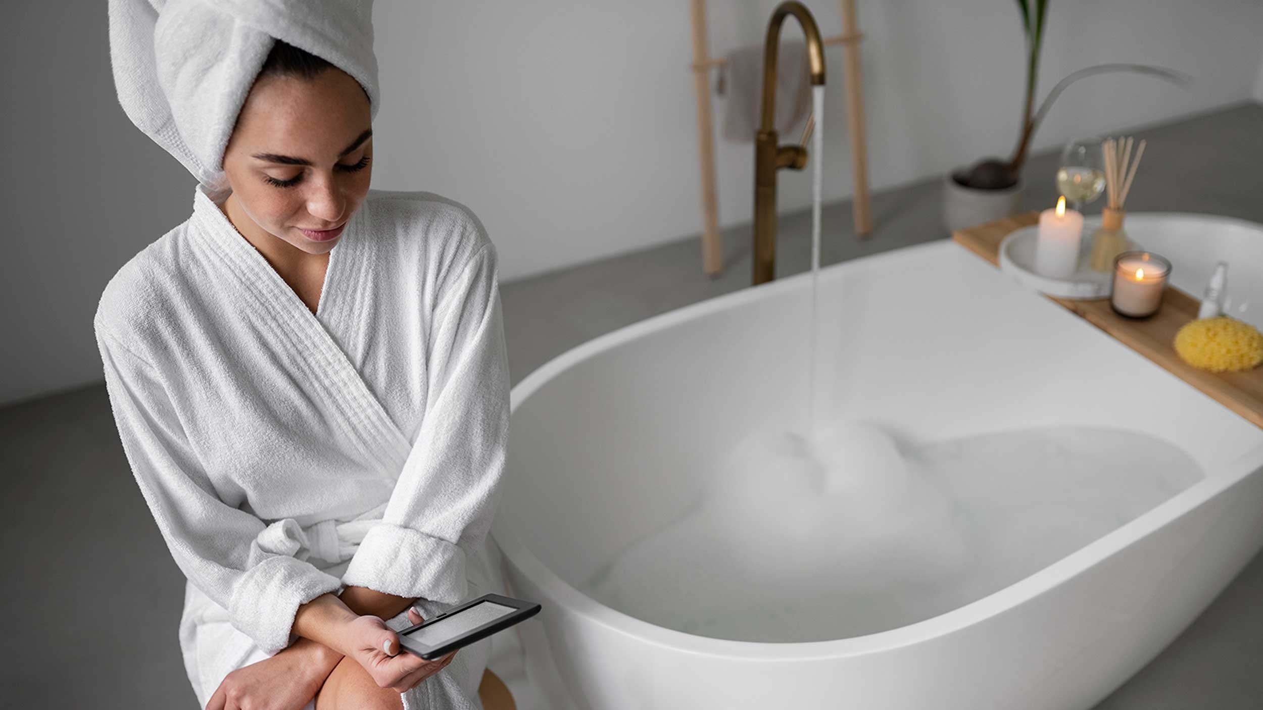 Photo of woman in bathrobes next to bathtub