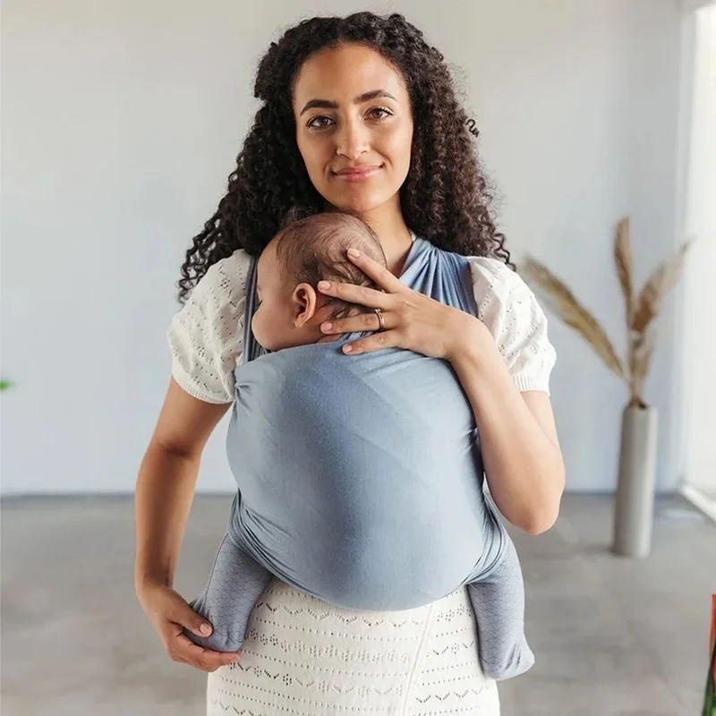 Mom wearing baby in baby wrap.