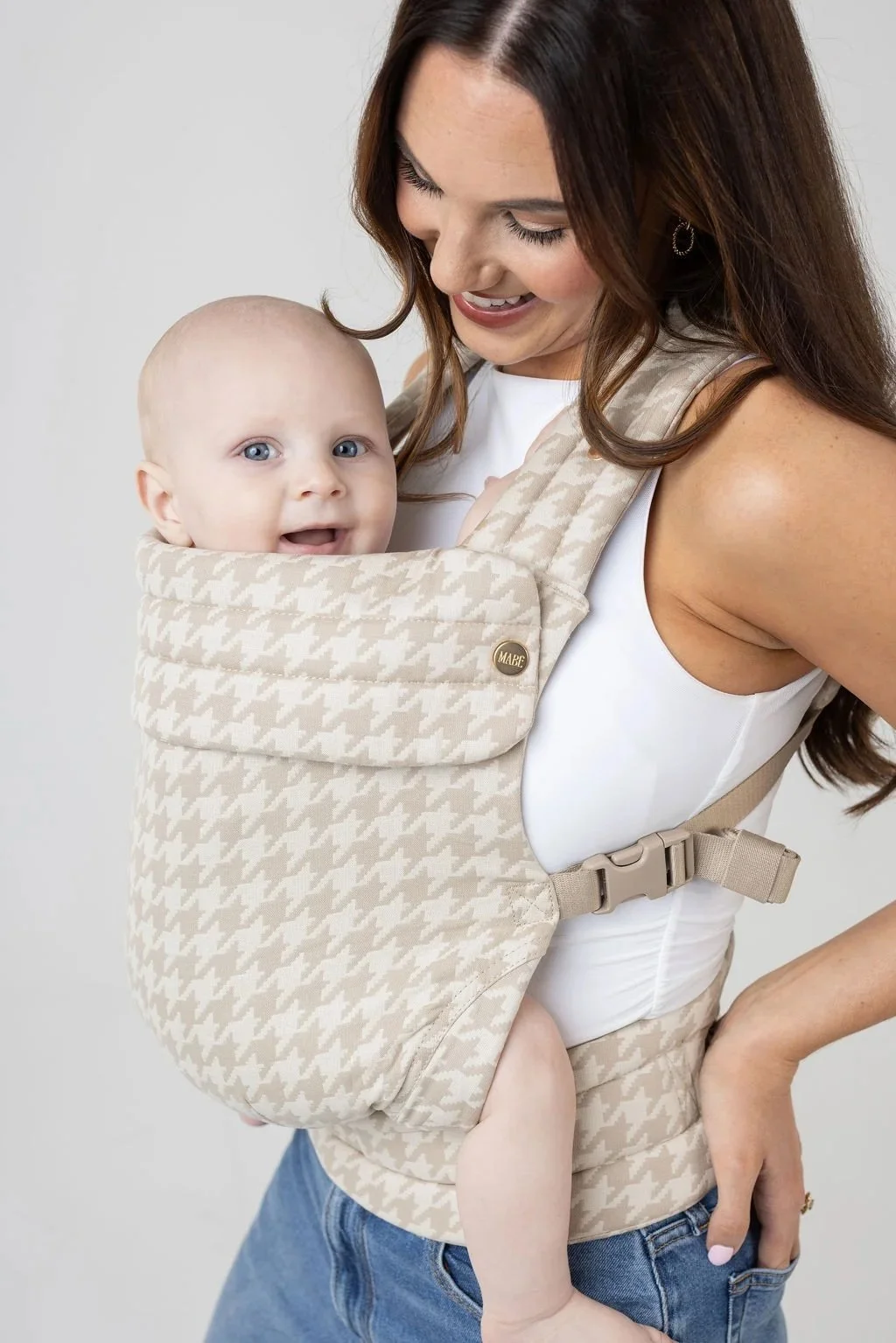 Mom wearing baby in structured baby carrier.