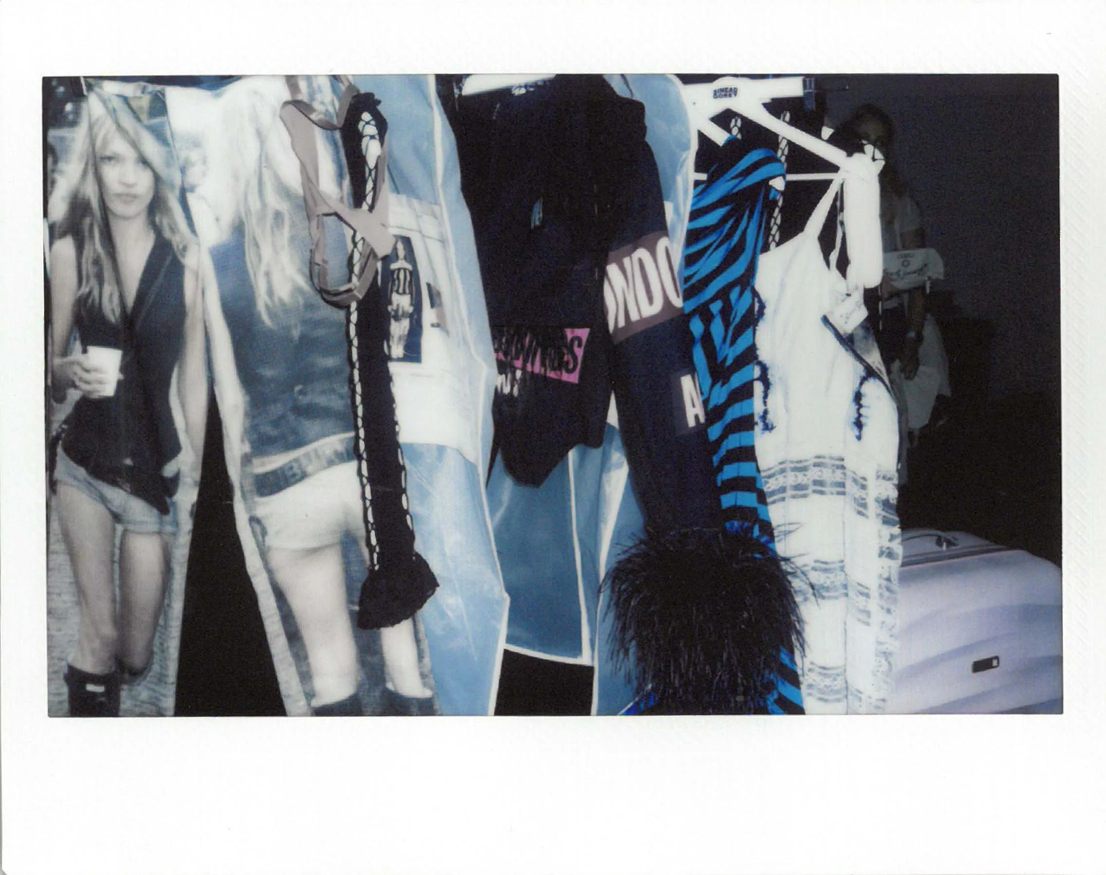 Clothing display with various dresses and garments from Sinead O'Gorey's collection hanging on a rack, some with striped and patterned designs, in a mix of black, white, and blue colours.