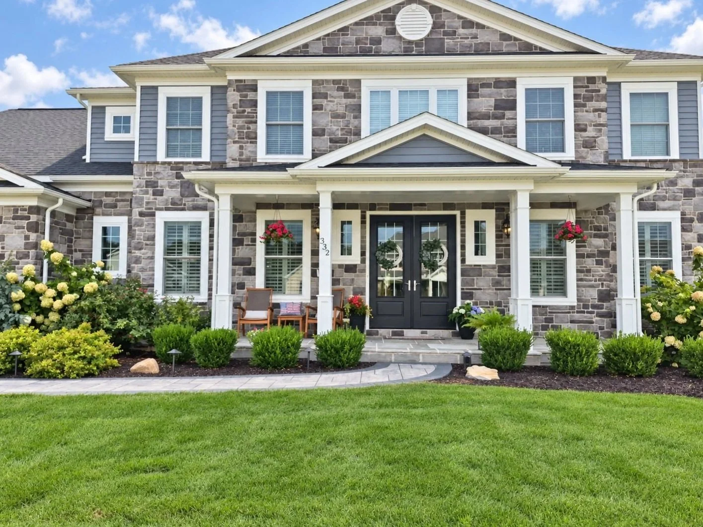 Front yard landscaping with lush lawn and foundation plantings