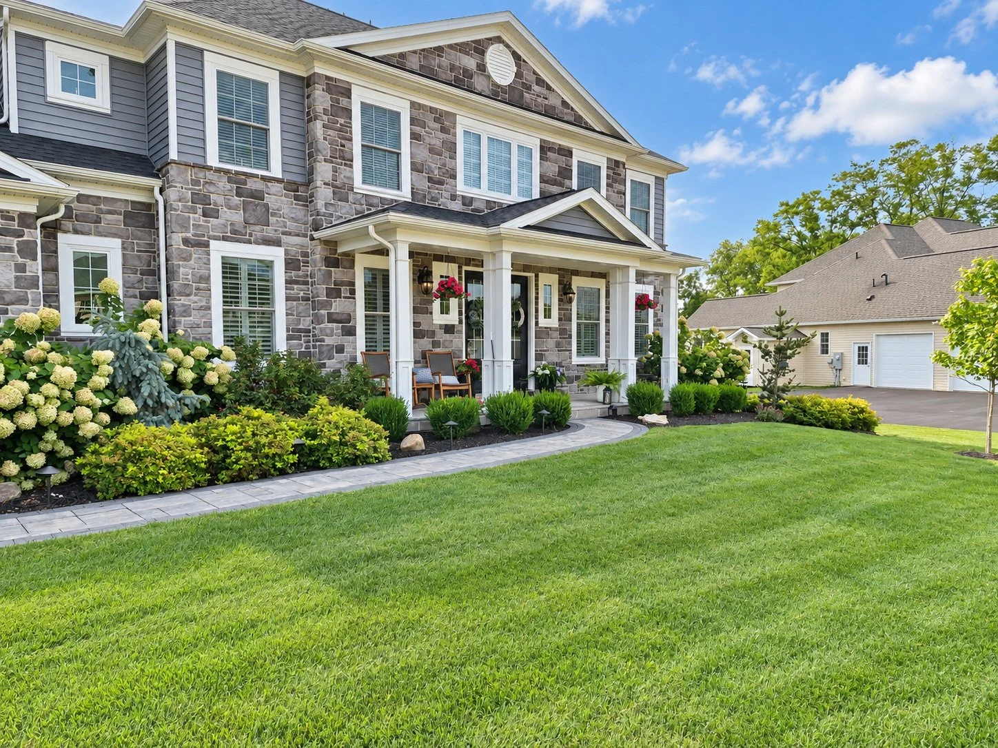 Front yard mowed lawn and paver walkway