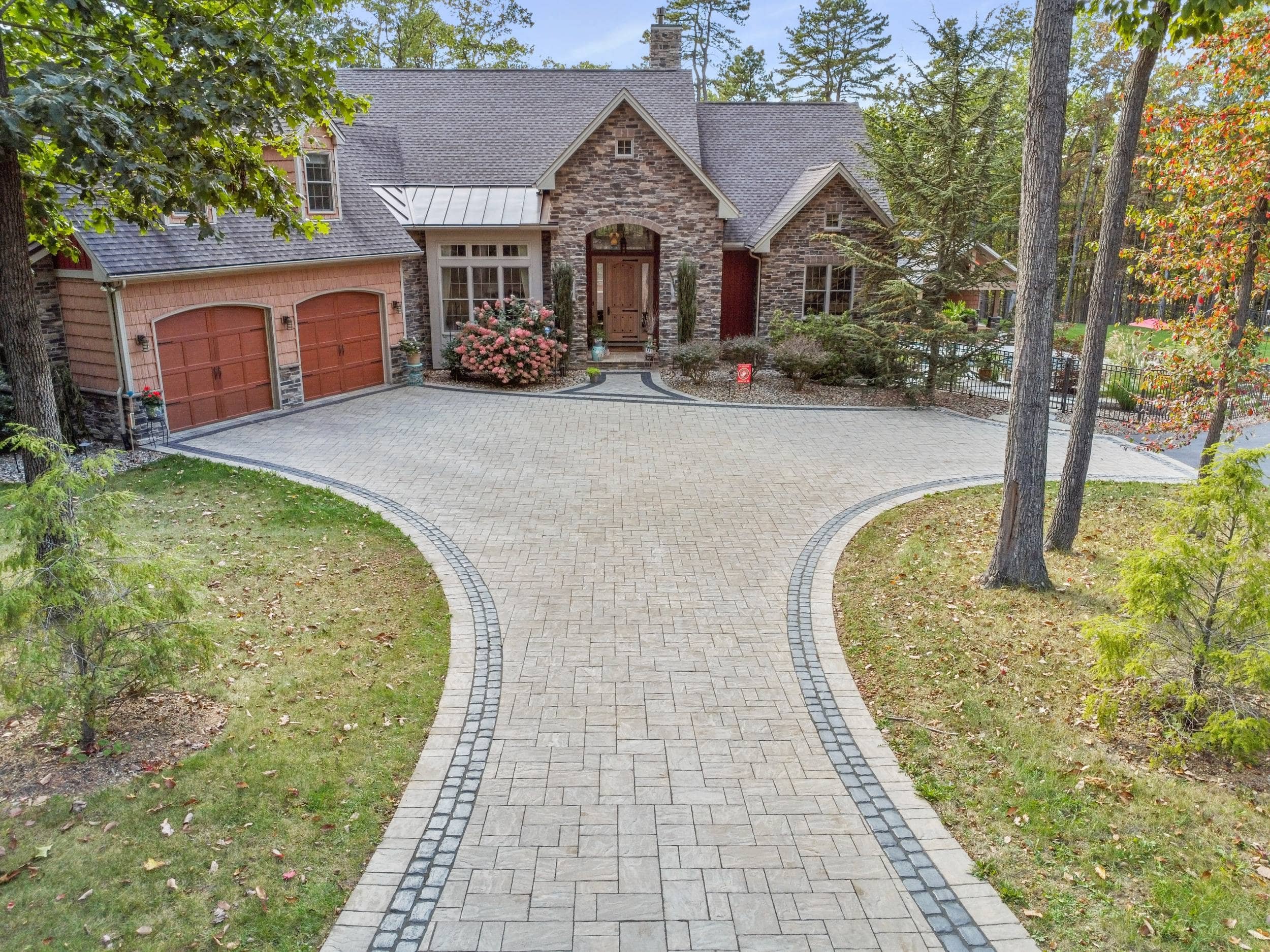 Landscape design project in Upper Allen Township, PA featuring paver walkway, water feature, and outdoor seating area