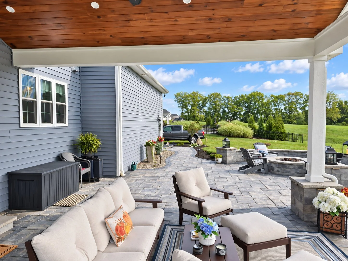 Outdoor patio seating area overlooking landscaped backyard