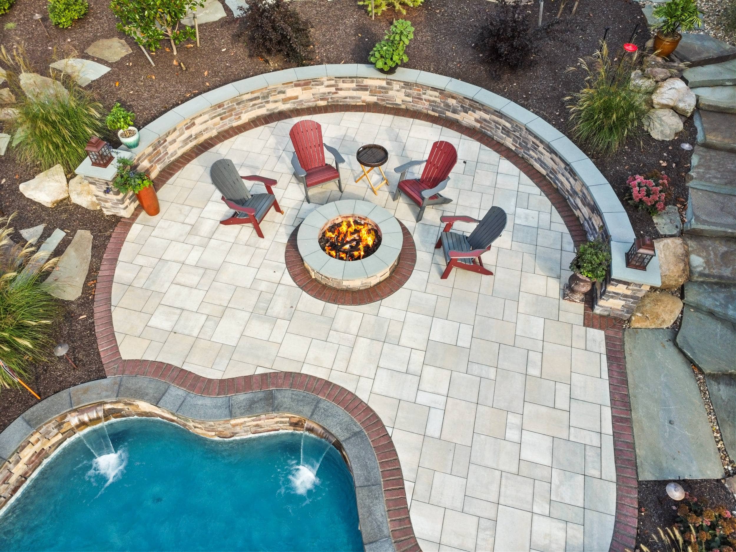 Outdoor fireplace and entertainment space designed by landscaping company near me in Hampden Township, PA