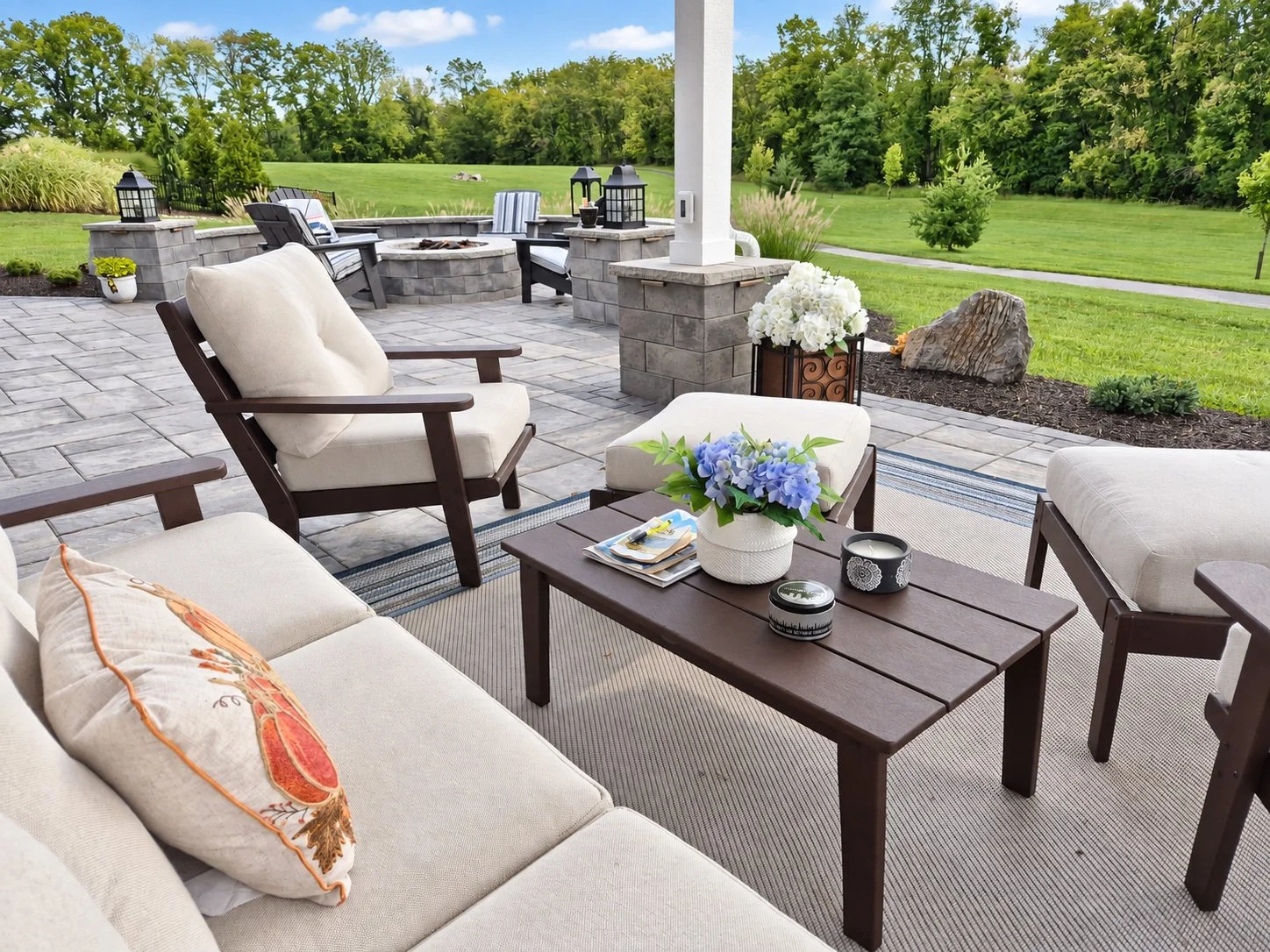 Large stone patio with outdoor dining and seating areas