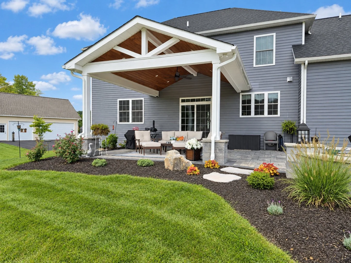 Manicured lawn and plantings in mulch bed