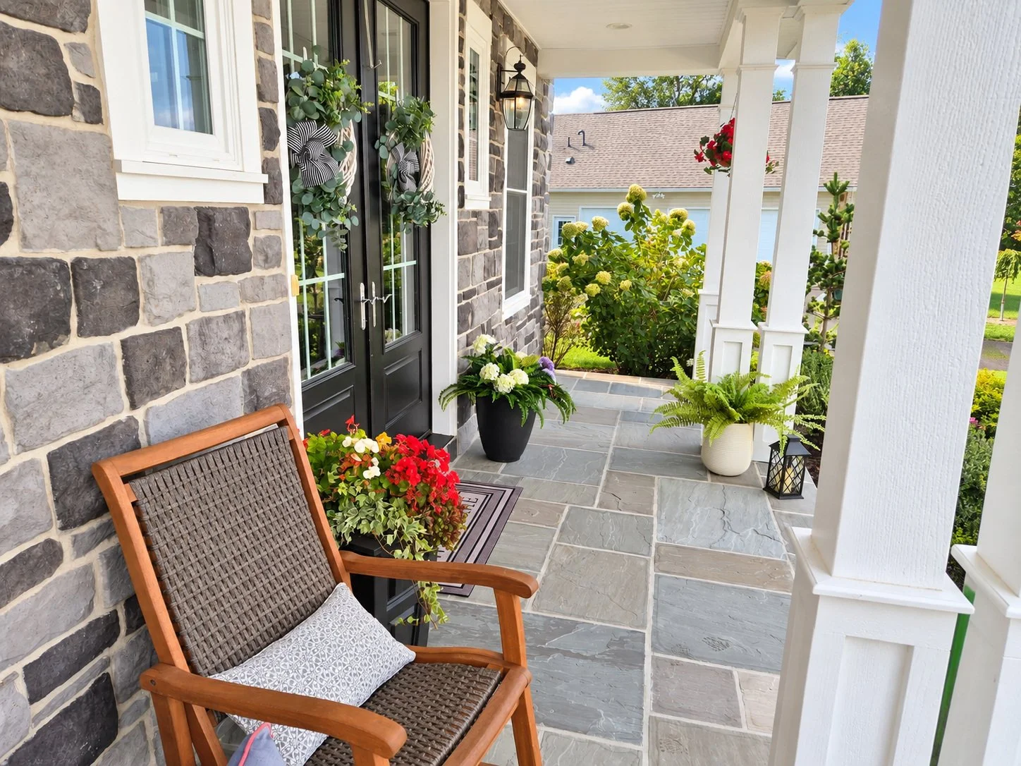 Covered front porch seating area beside landscaped entry
