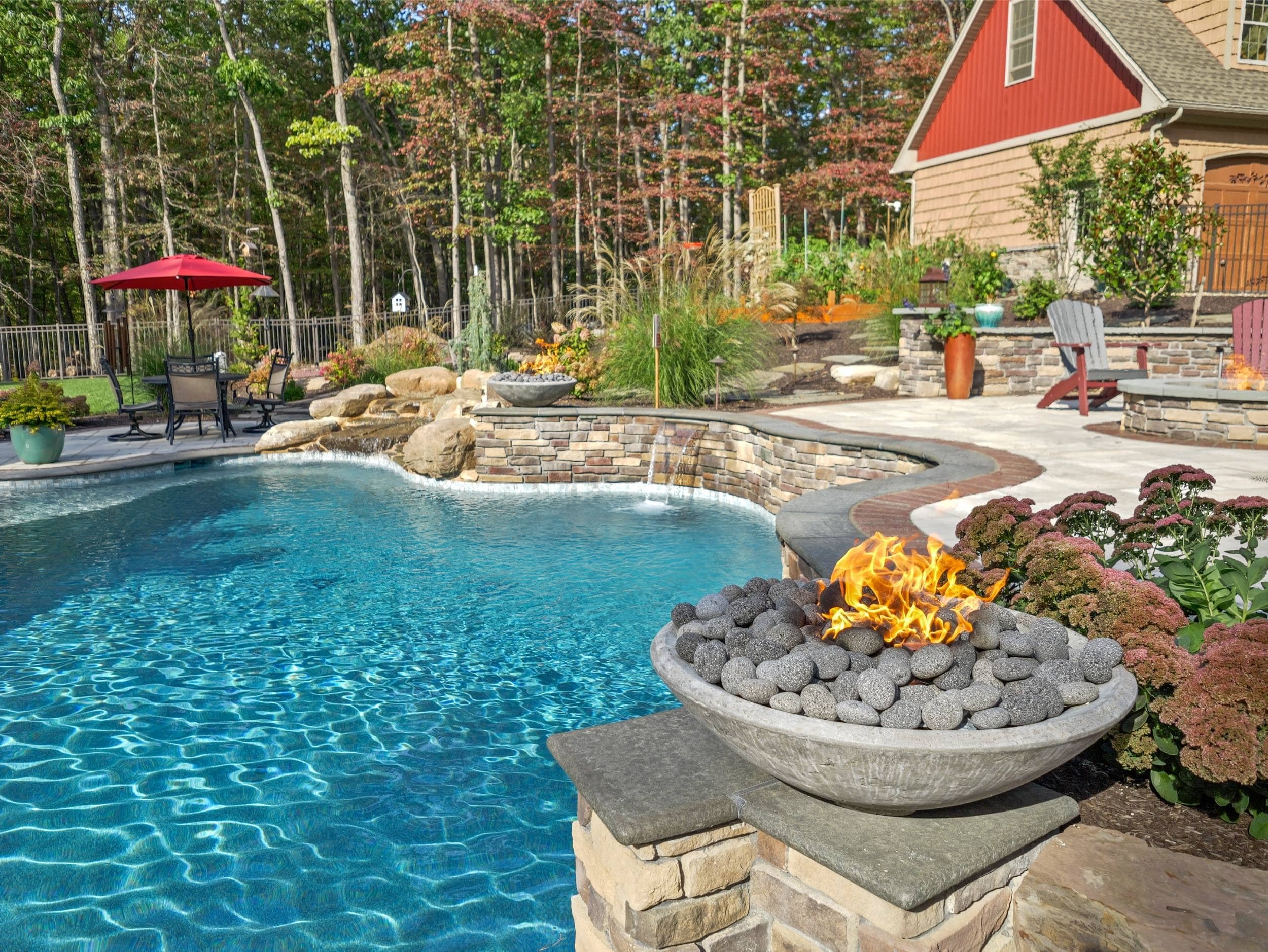 Fire pit seating area and soft outdoor lighting installed by landscapers in Southampton Township, PA