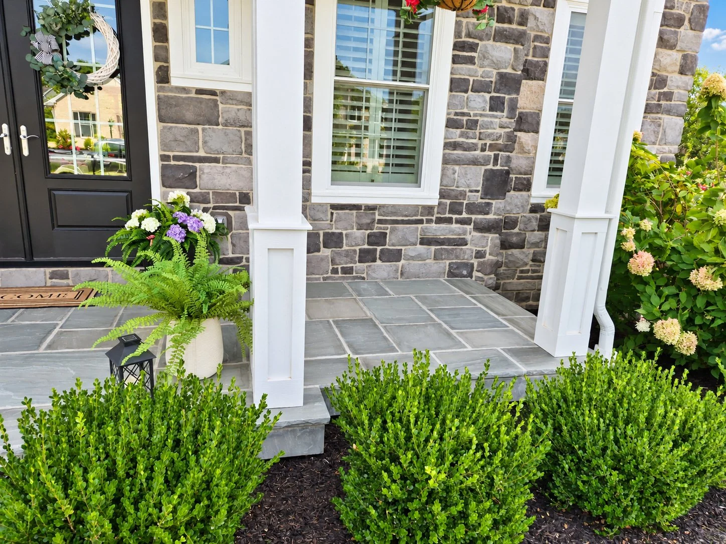 Front entry landscaping with shrubs and foundation plantings