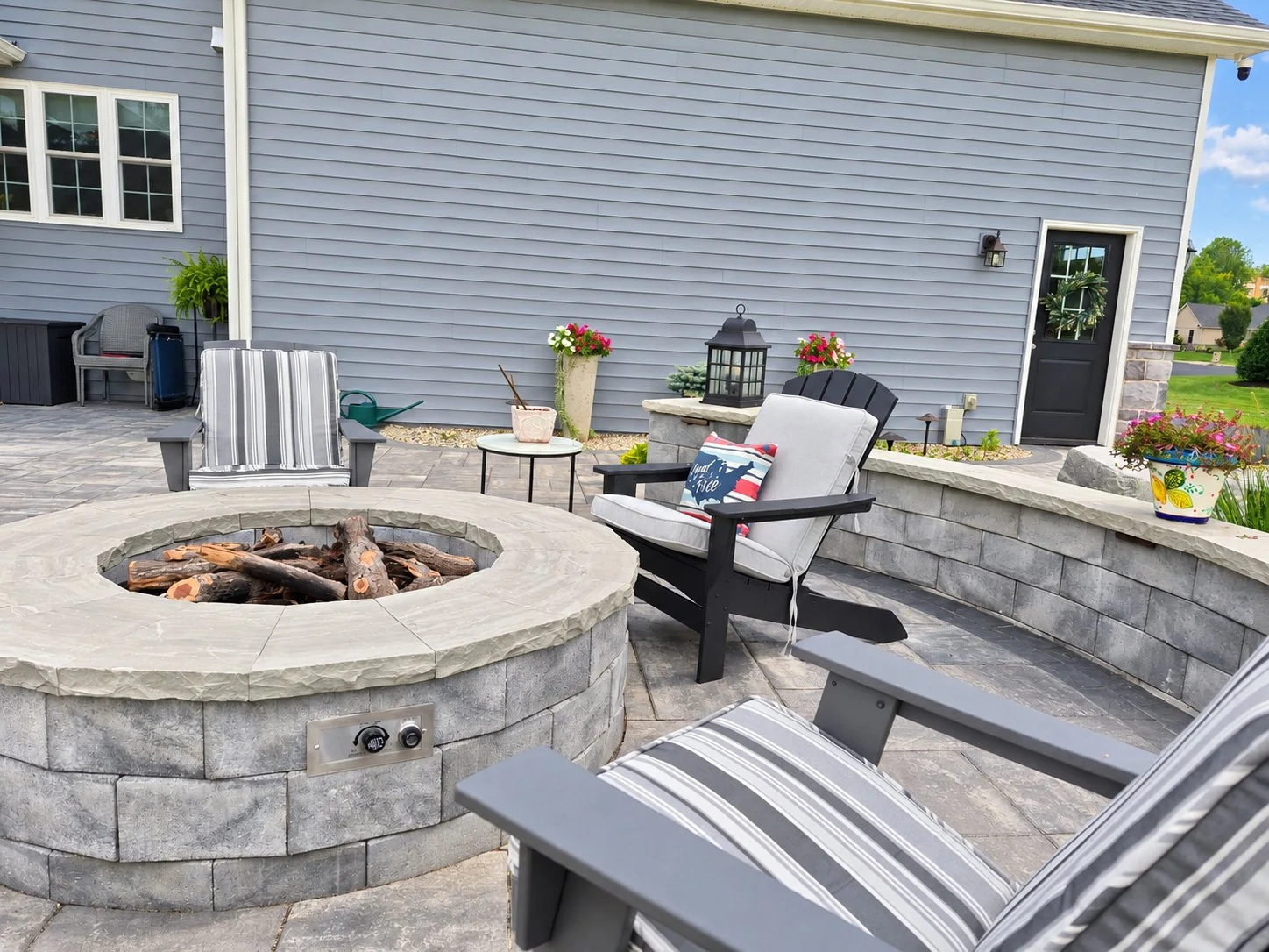 Stone fire pit surrounded by outdoor patio seating