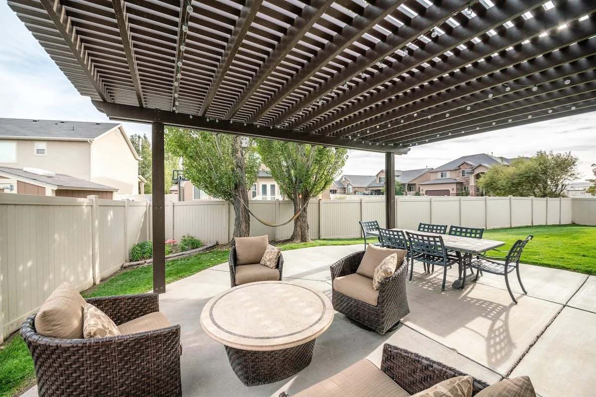 Louvered pergola in small backyard dining area