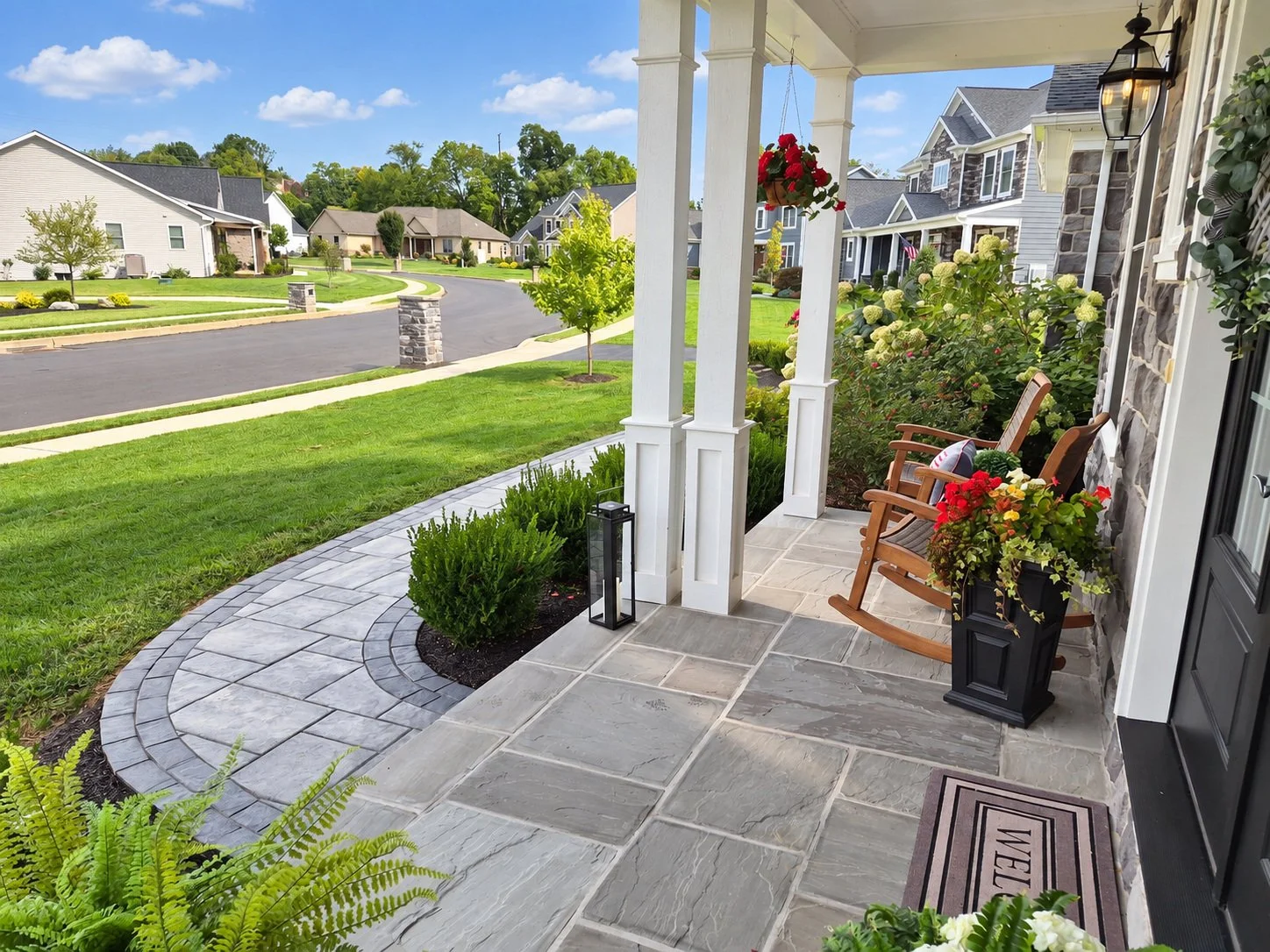Front porch entrance with walkway and manicured landscaping