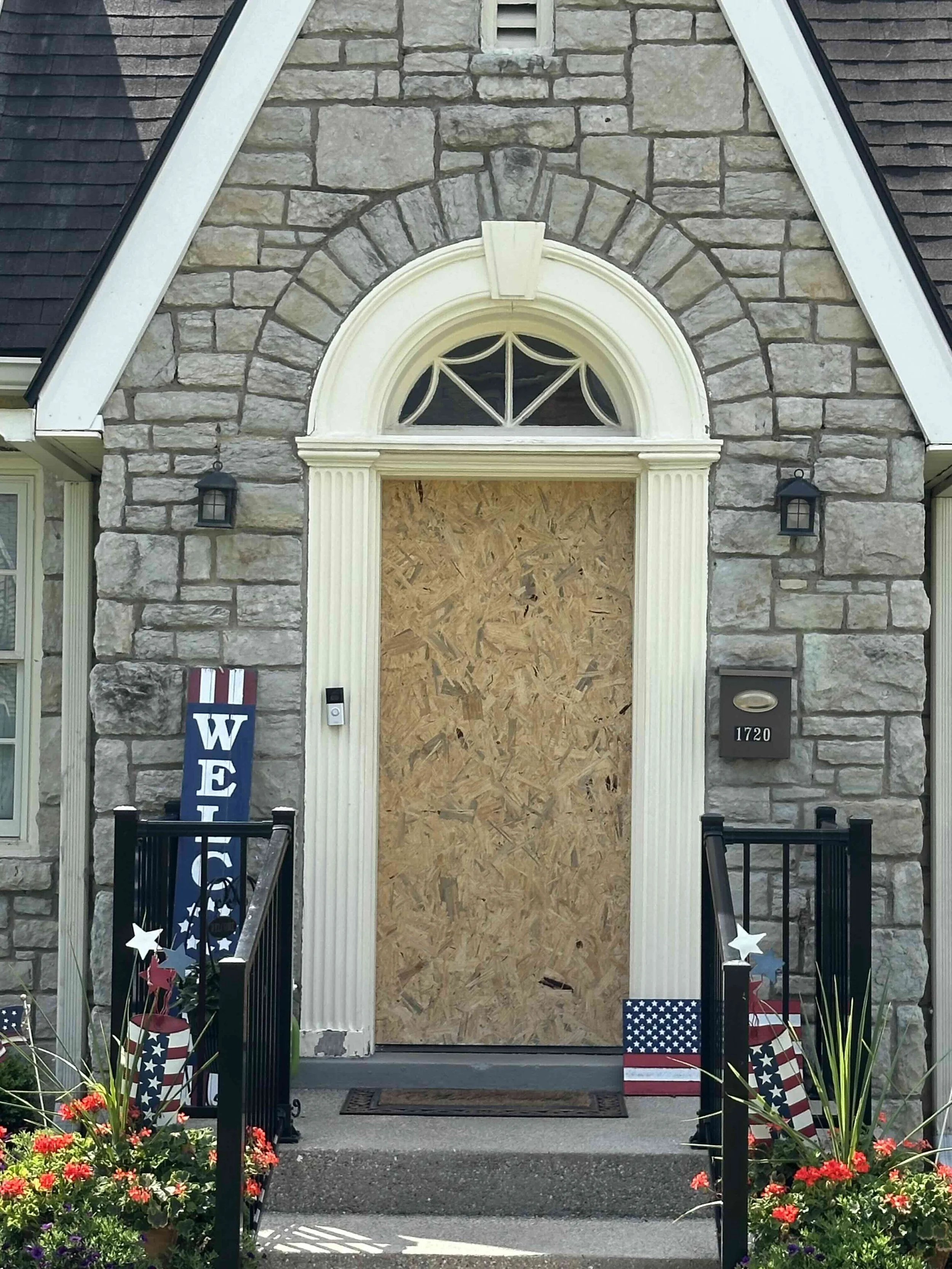 the boarded up opening is waiting for a front door replacement in historic Louisville ky