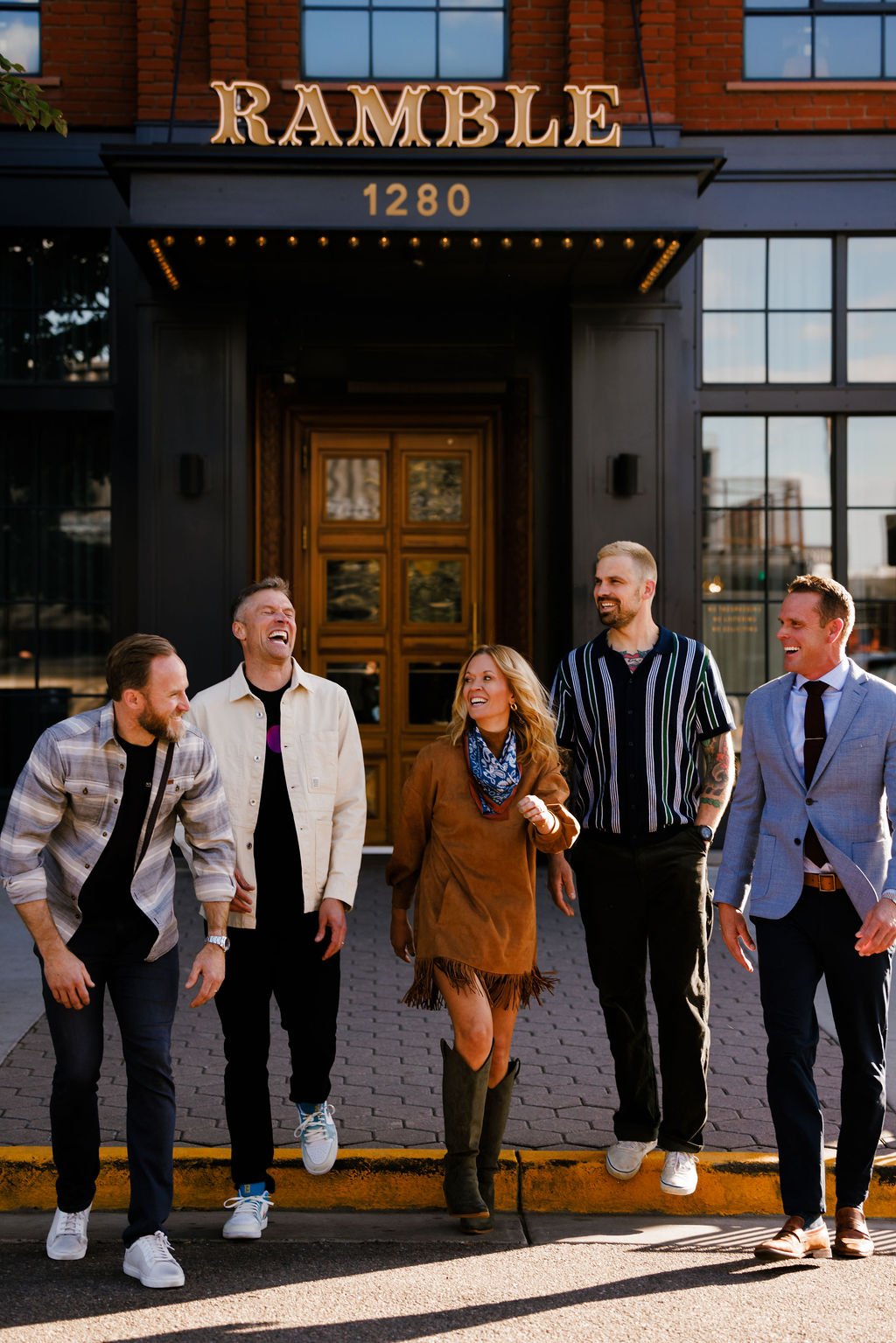 a photo of Brad Leavitt, Nick Schiffer, Morgan Molitor, Tyler Grace and Mark Williams: Contractor Coalition Summit Hosts in front of the Ramble Hotel in Denver