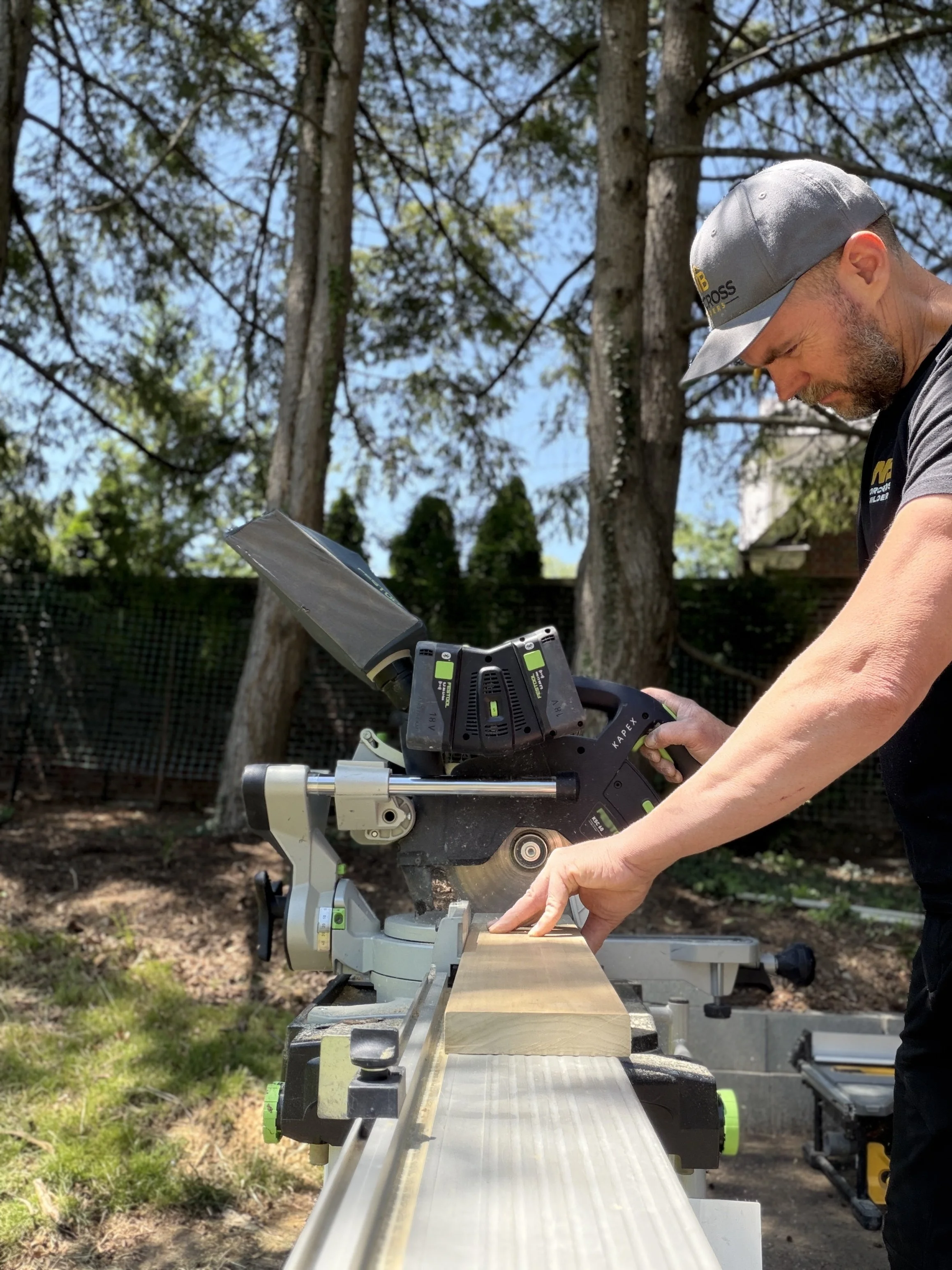 a photo of the owner of Norcross Builders operating a chain saw, while working on a historic remodel in the Highlands, Louisville KY