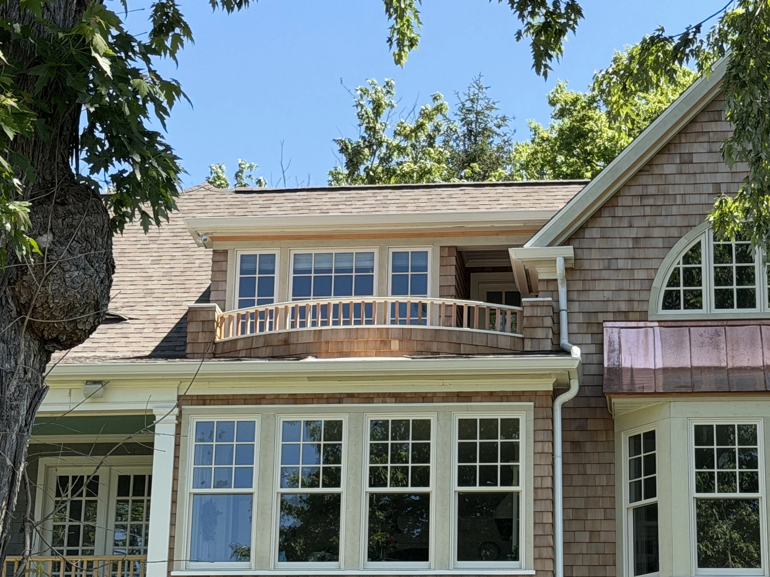a photo of a curved ipe deck, cedar shake siding on a historic home in Prospect KY