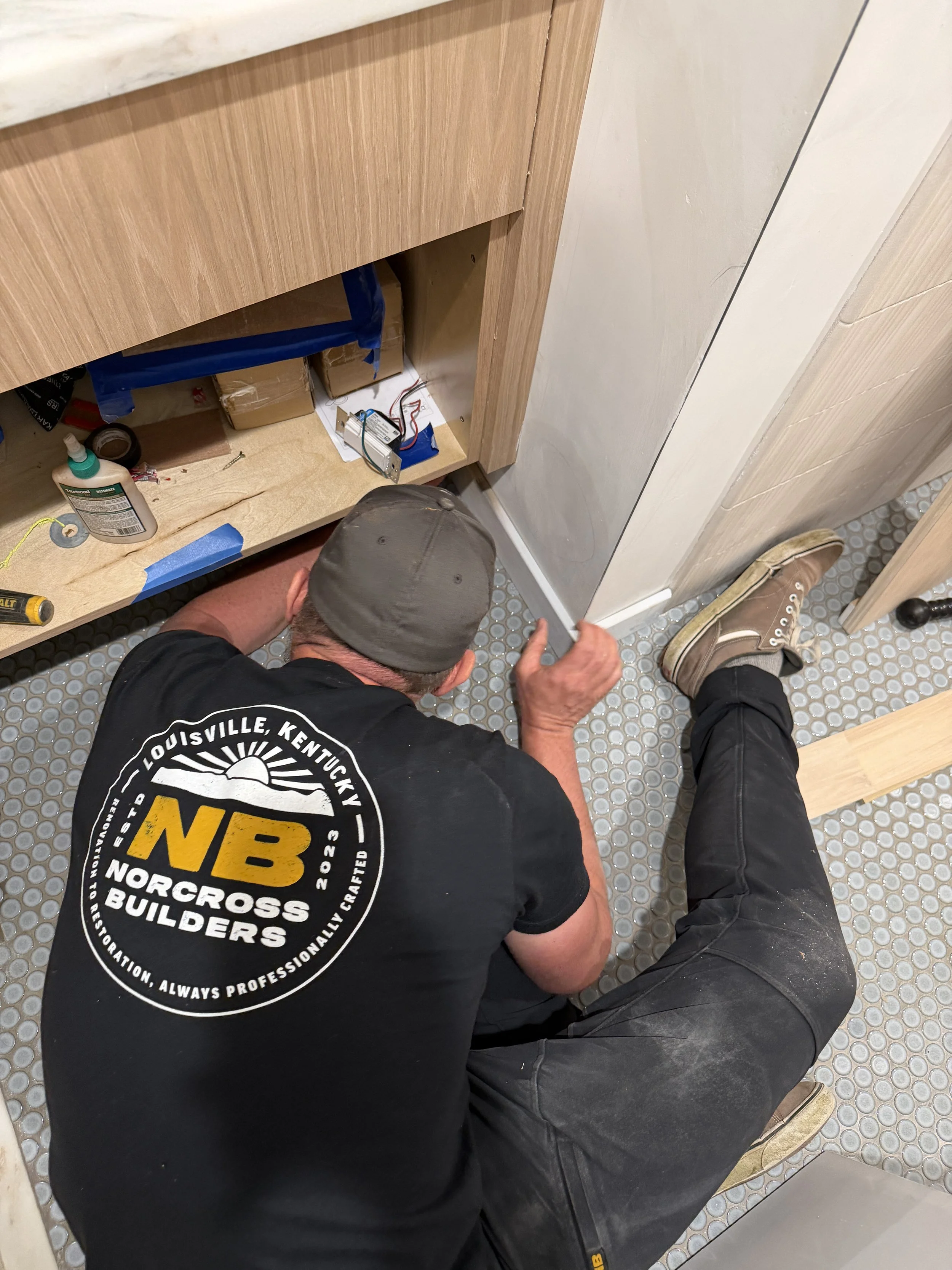 Norcross Builders, General Contractor in Louisville is hands-on working on a single bathroom vanity