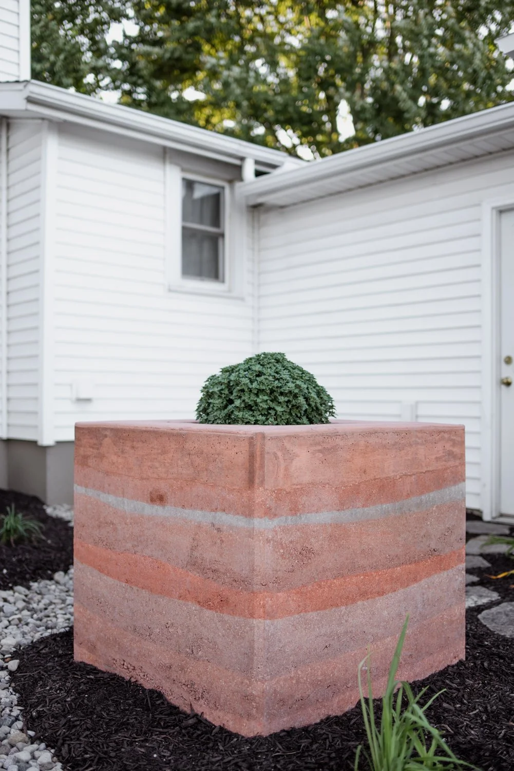 Rammed earth planter box in Wauseon, Ohio designed and built by Solstice Design Studio 